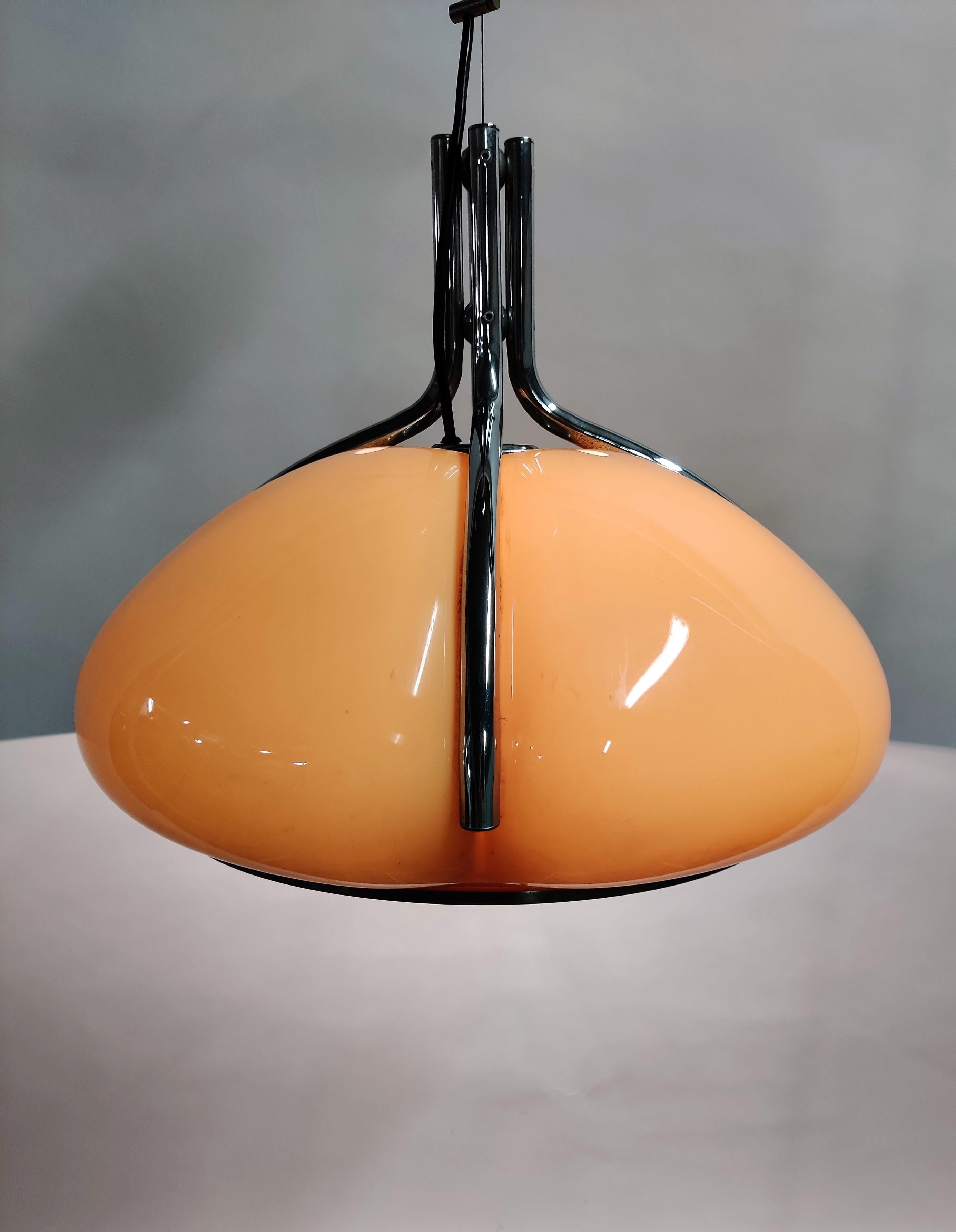 This Italian pendant ceiling light was made in the 1970s. This lamp was designed and manufactured by the Harvey Guzzini Design Team. 

The model is called 'Quadrifoglio' which means 'four parts'.

The lamp is made from synthetic plexiglass. This