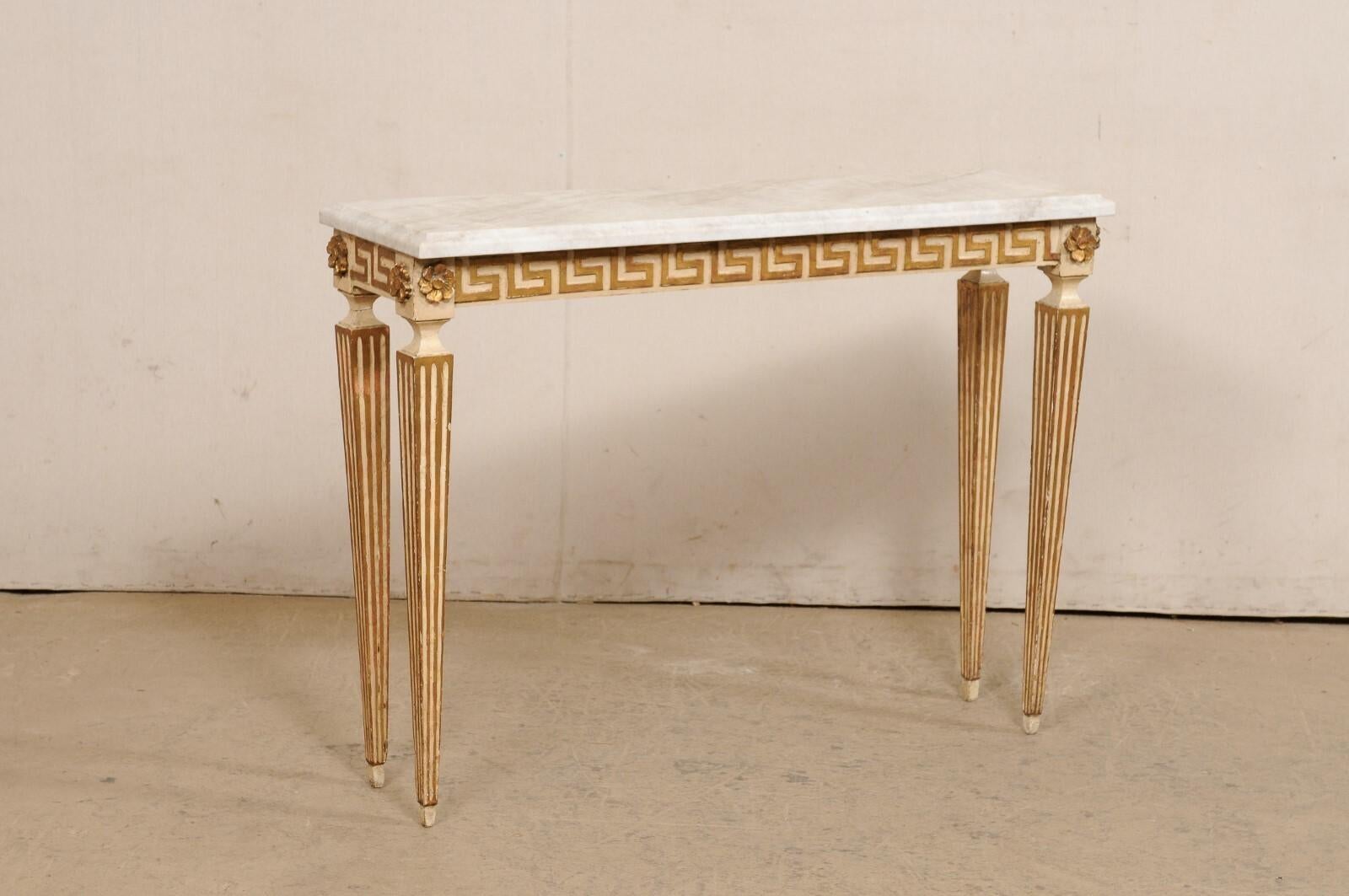 An Italian slender console table, with greek key motif and new stone top. This vintage table from Italy has a new rectangular-shaped quartzite top with beveled edges, which rests atop an apron which is adorn in a Greek key motif, with fabulous