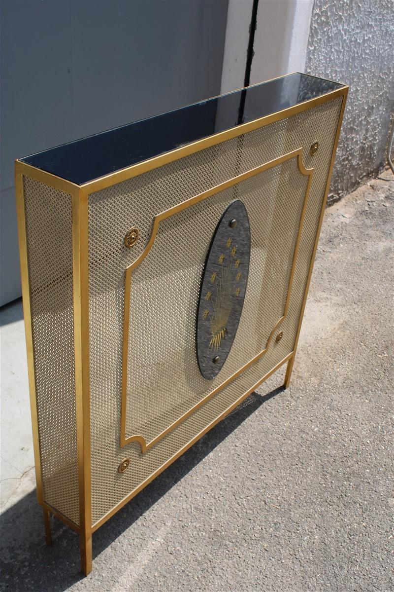Italian radiator cover midcentury in perforated iron parts in pure gold 1950s.
Upper surface in mirror, truly original pieces of great elegance.

 