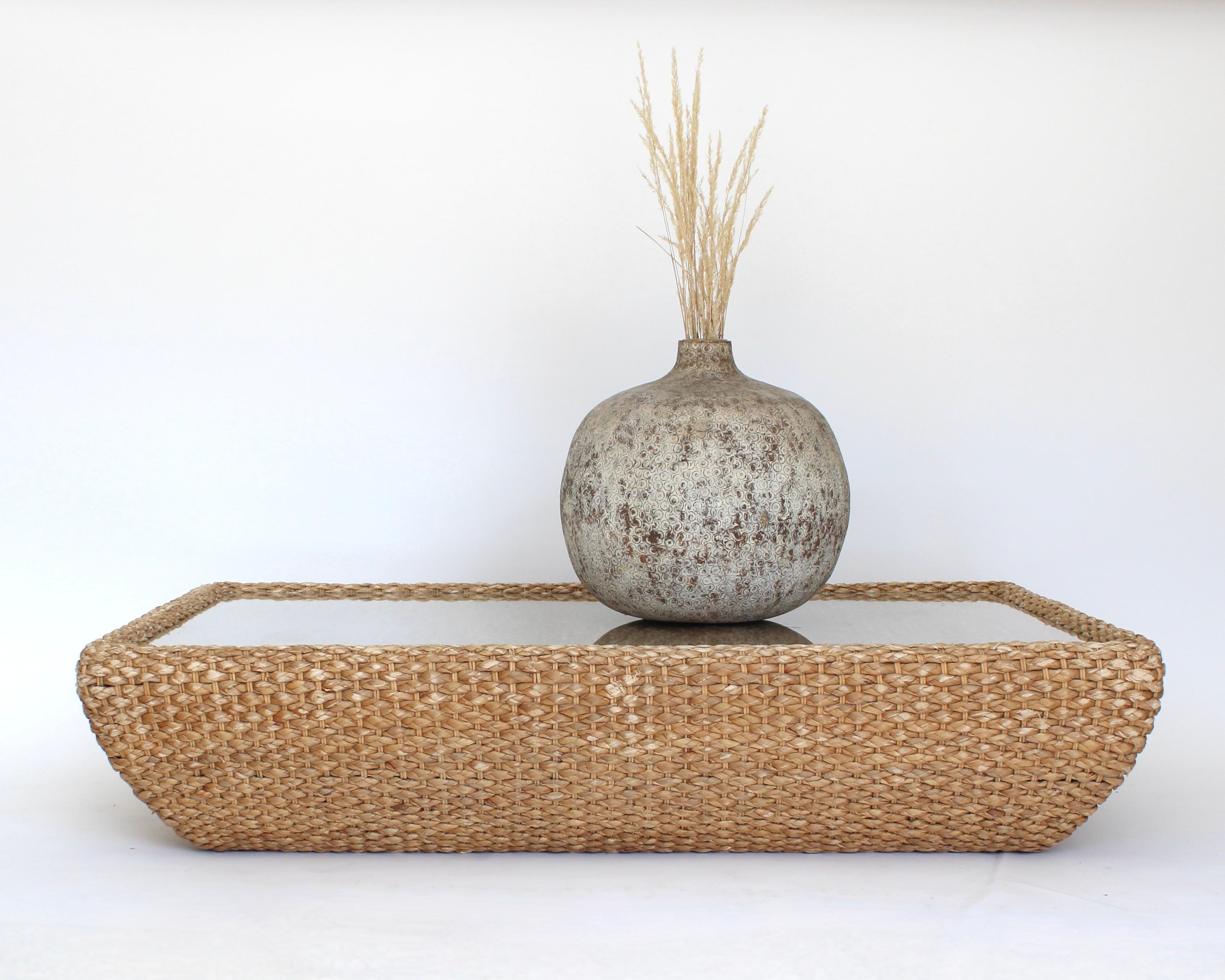 Large glass topped raffia woven based rectangular coffee table that sits directly on the floor. Great beach house vibes. Natural materials make this coffee table perfect for the beach, Malibu or desert location. 
Great condition with no tears to the