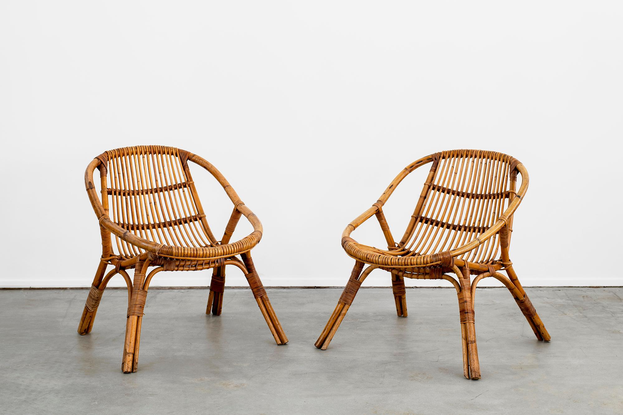 Sculptural pair of Italian rattan chairs with wonderful scoop shape.