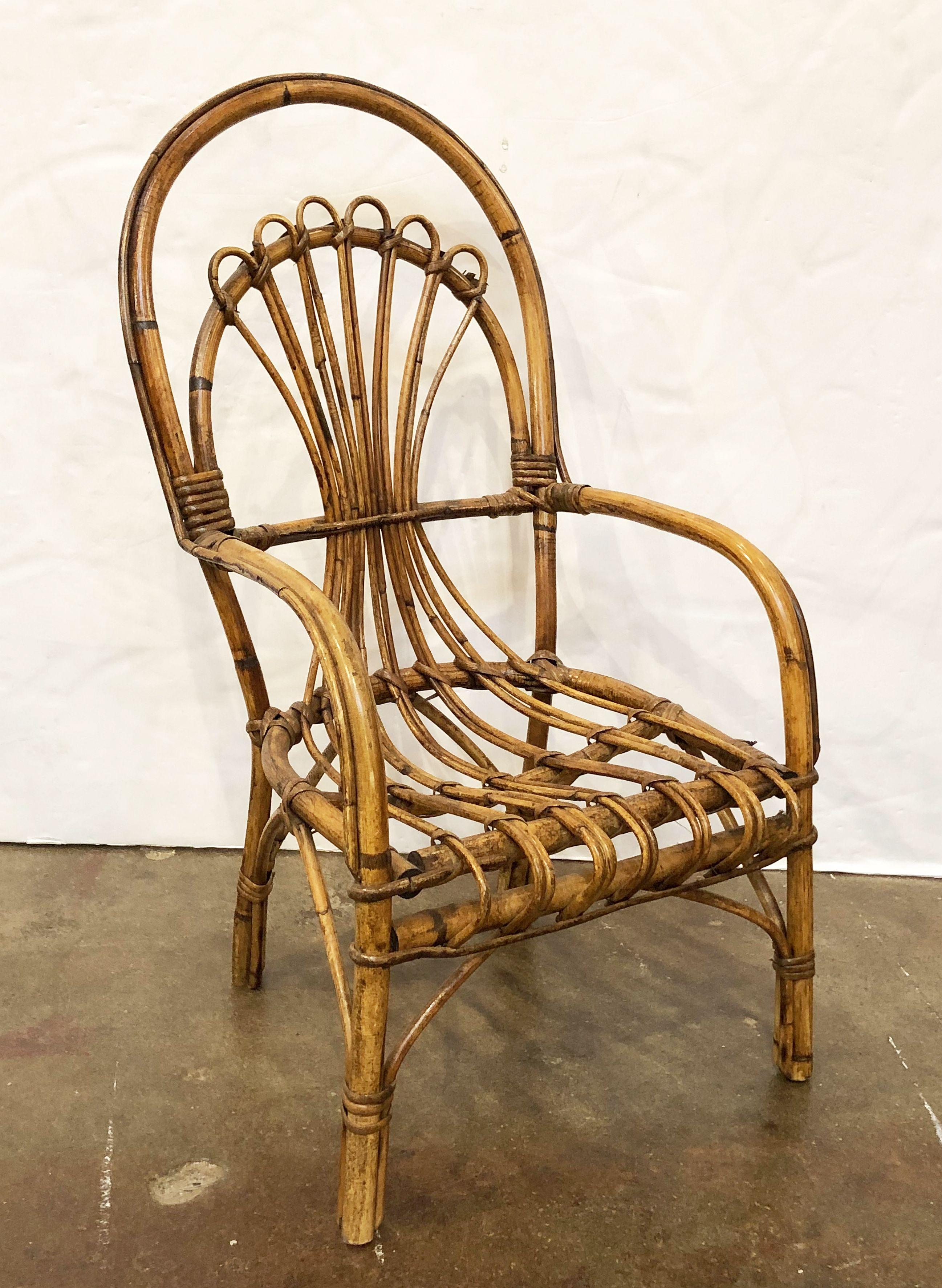 A fine pair of vintage Italian fan-backed children's or child sized chairs from the Mid-20th century, of woven rattan and bamboo featuring a stylish design to the back, seat, and legs.

Two available - Individually priced - $595 each chair