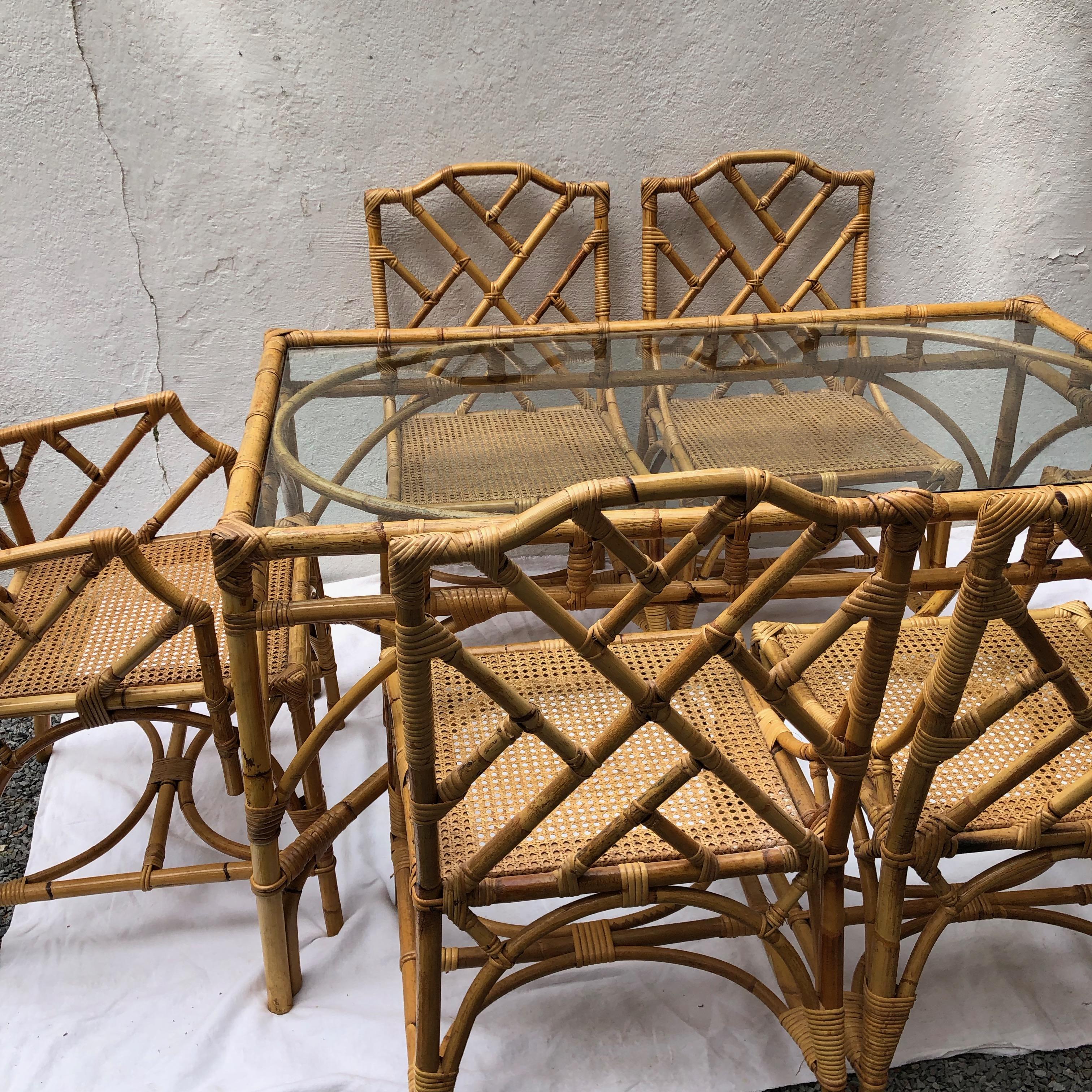 Chinese Chippendale style / Italian rattan and cane dining set by Dal Vera including dining table with glass top, two armchairs and four chairs in the style of Gabriella Crespi

Measures: Table 29