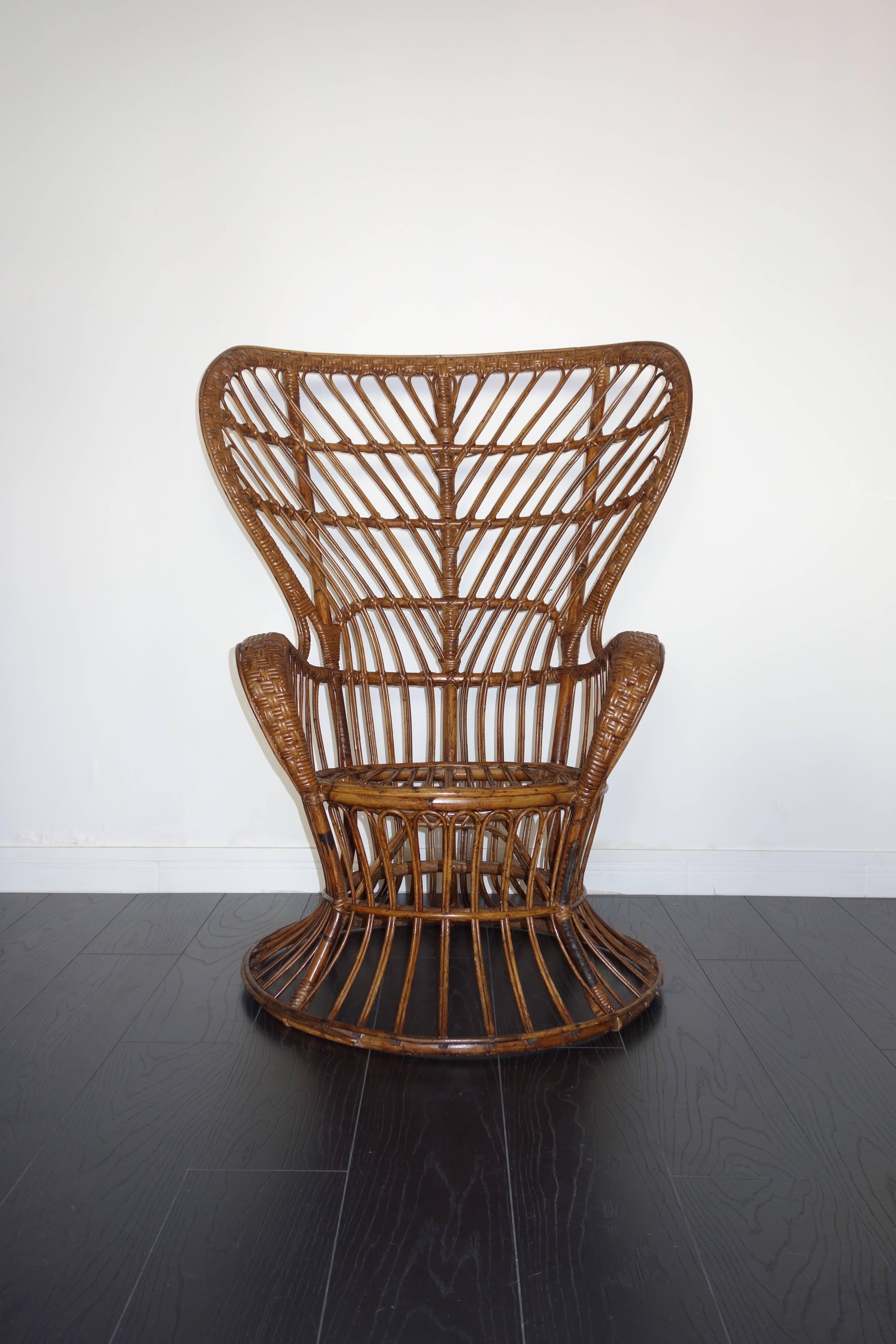 Rattan armchair by Lio Carminati for Bonacina. Italian handmade manufacture of the 1950s. Model created for the ship Conte Biancamaro. In its original state. In very good condition: beautiful patina, varnished original well preserved, comfortable