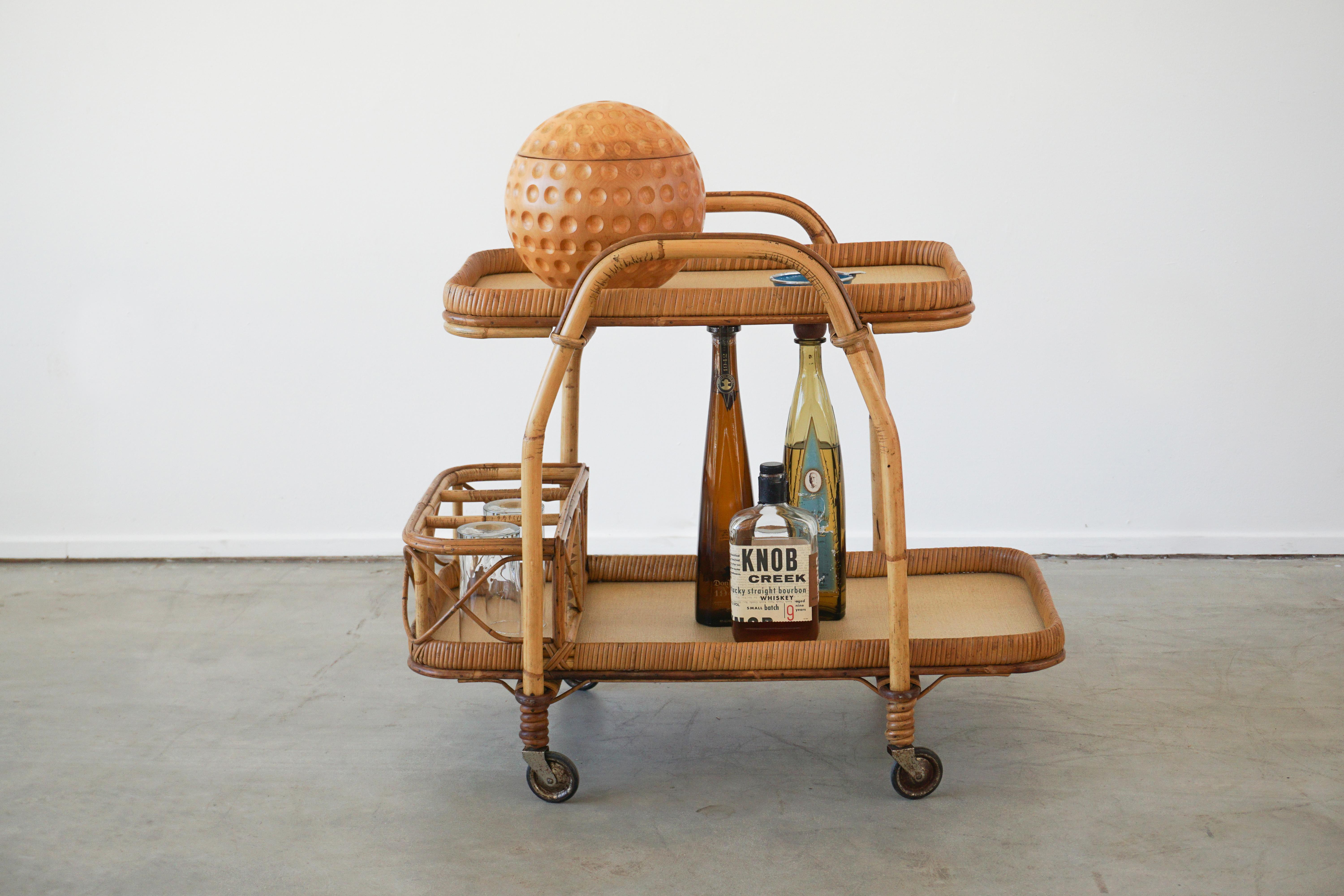 Italian rattan bar and wicker bar cart with fantastic curved lines. 
Original casters. 
Italy, circa 1950s. 

 