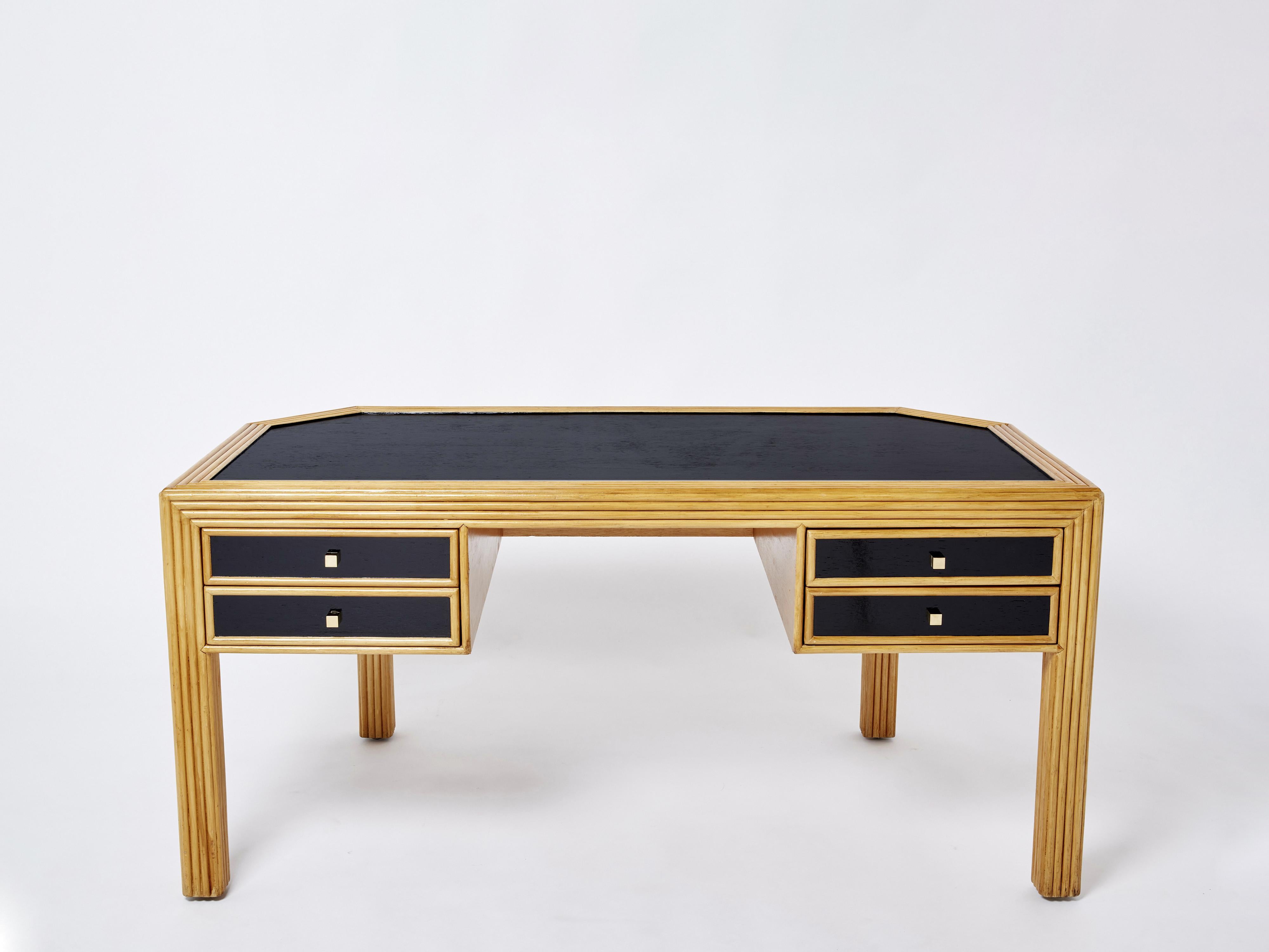 This is a beautiful Italian rattan executive desk from the 1970s. The mix of rattan, black painted wood all around, and brass handles, is inspired by mid-century Italian icon Gabriella Crespi and the French Riviera trend from the 1960s and 1970s.