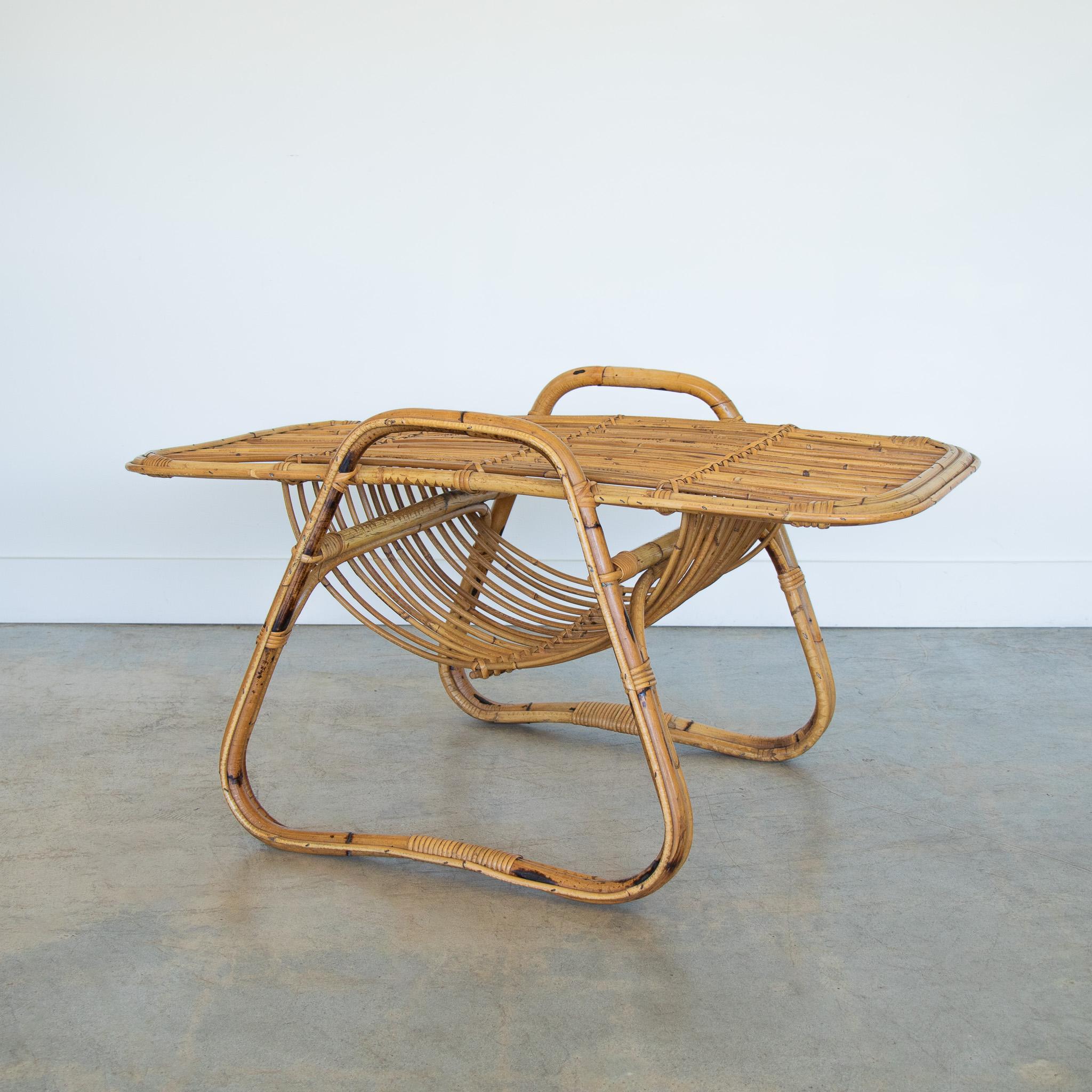 Unique rattan coffee table from Italy, 1960's. Slatted rattan top with handle detail and curved lower level perfect to hold magazines. Original finish show great age and patina.