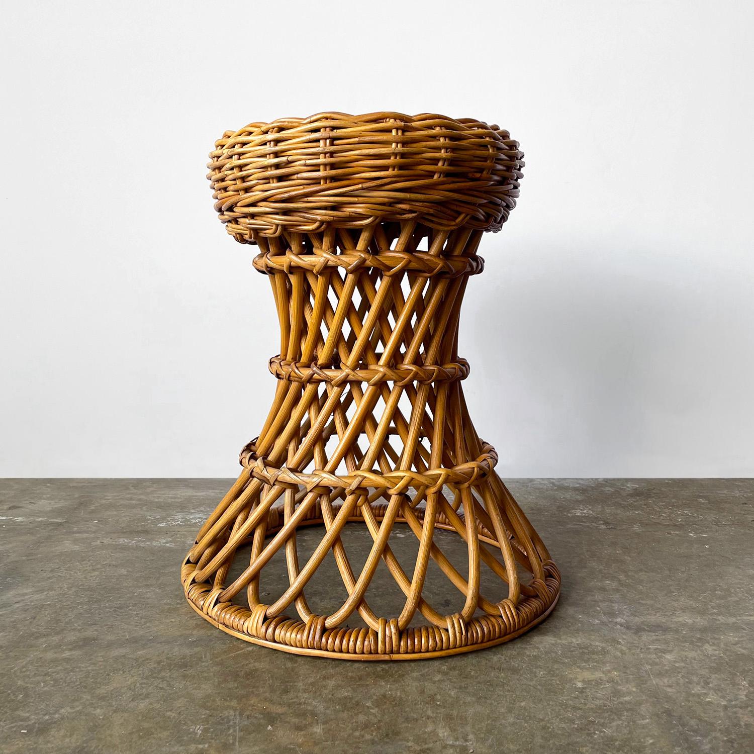 Italian rattan hourglass stool
Italy, circa 1960s
Beautifully handcrafted piece 
Constructed of intricately woven wicker and rattan reeds
Newly reconditioned
Patina from age and use
This listing is for a single stool
Last photo for Size