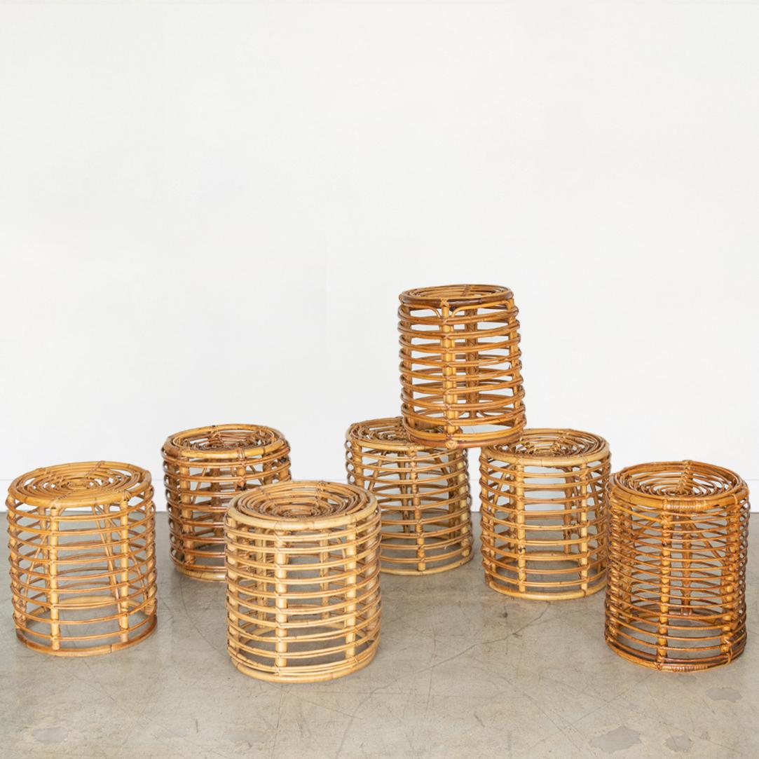 Vintage 1960's circular rattan stools by Tito Agnoli. Original rattan with nice age and patina. Multiple available and sold individually. Great as stool or table. Varying sizes available. Please inquire for exact heights. 