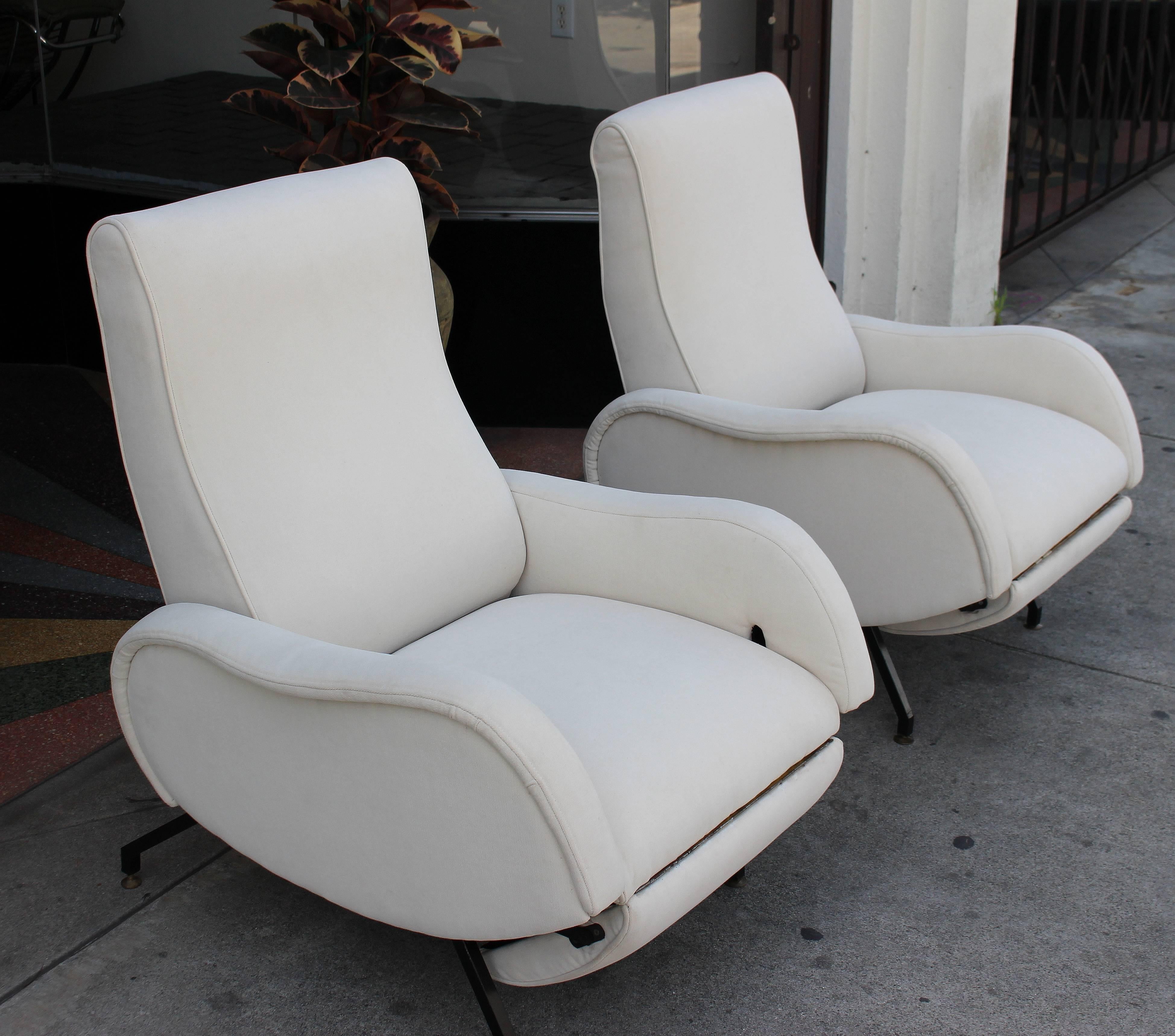 1950s Italian recliner chairs, new upholstered and refurbished. Metal legs and brass bouts. Chairs total extended length is 60 inches.