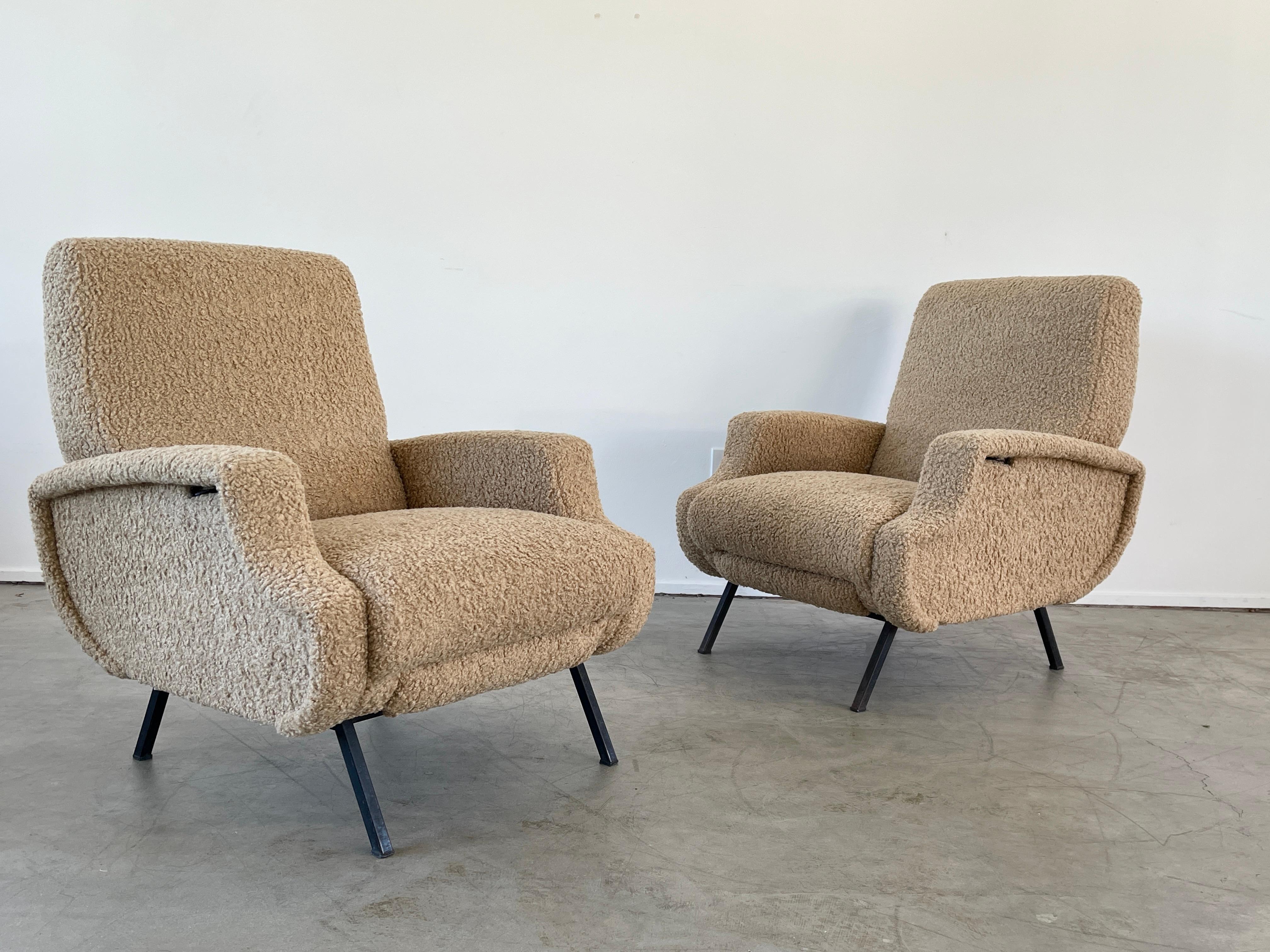 Wonderful pair of Reclining Italian lounge chairs with iron base and reupholstered in camel wool boucle. 

Unique design has mechanism to allow back seat to recline in multiple degrees as well as a pull out foot rest. 

Great for a media room!