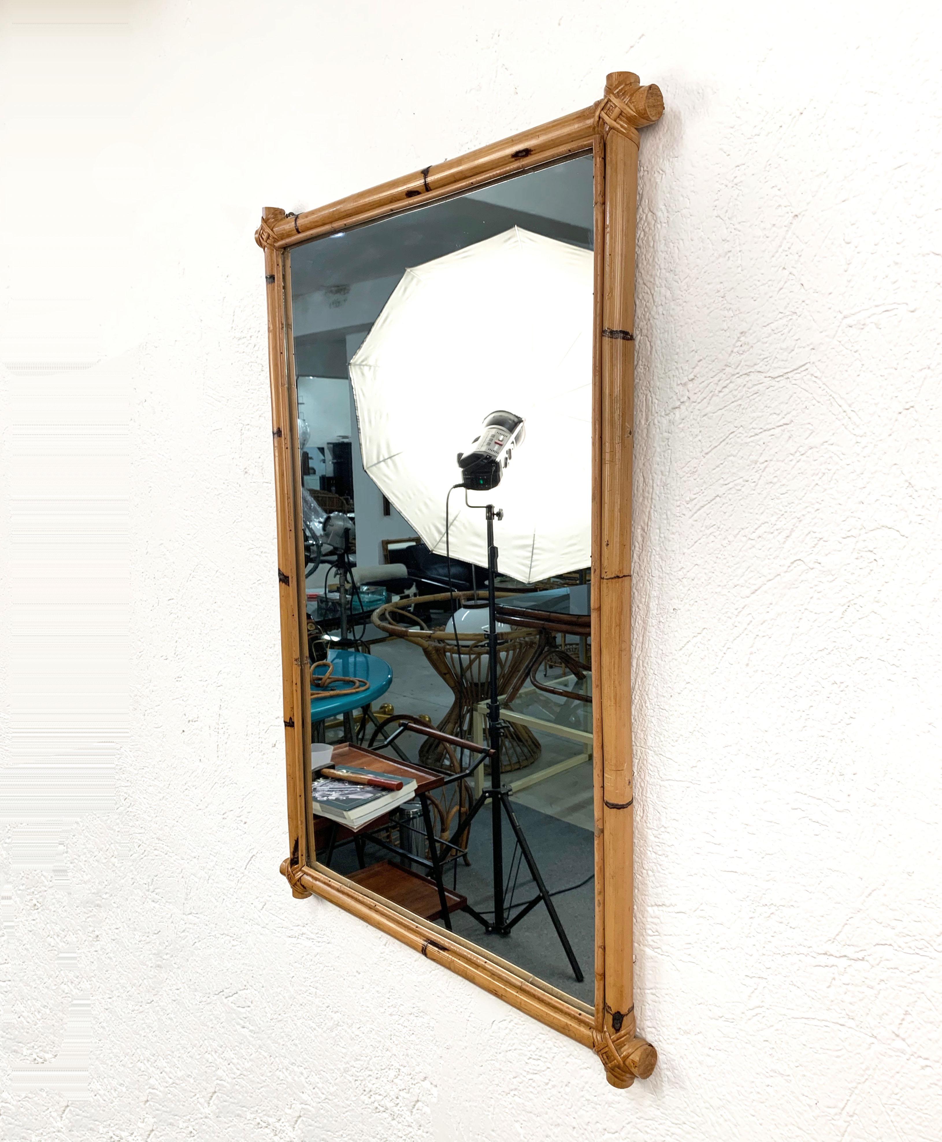 Midcentury rectangular mirror produced in Italy during the 1970s.

 It made of a large and small bamboo stick on each side and woven wicker on the corners.

This item as a savage flair due to the large bamboo stick not ending on the wicker
