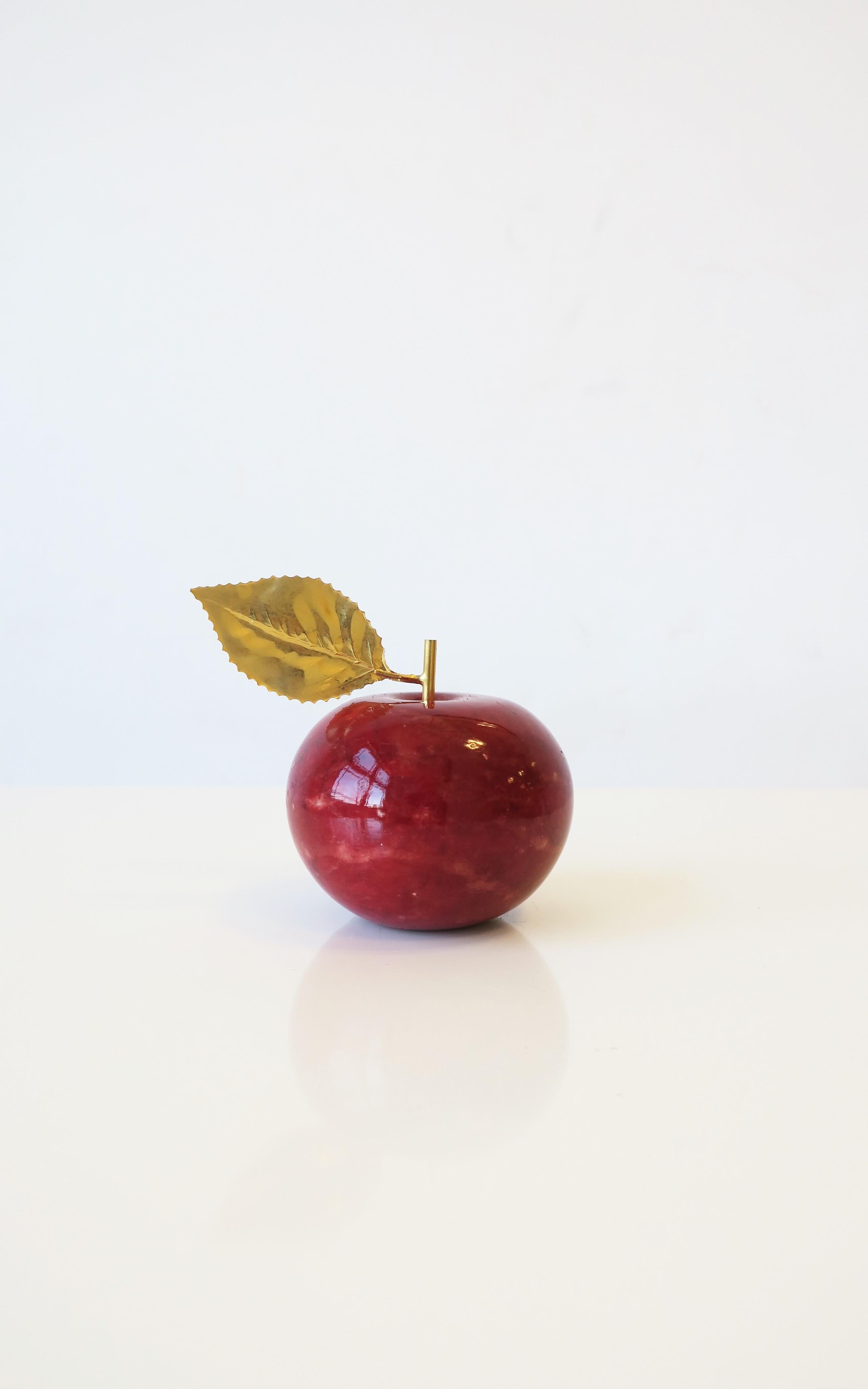 An Italian red alabaster marble apple with brass gold leaf, circa late-20th century, Italy. This beautiful red apple is made in Italy and hand-carved as marked. I great decorative object on a shelf, credenza, desk, etc. Dimensions: 2.63