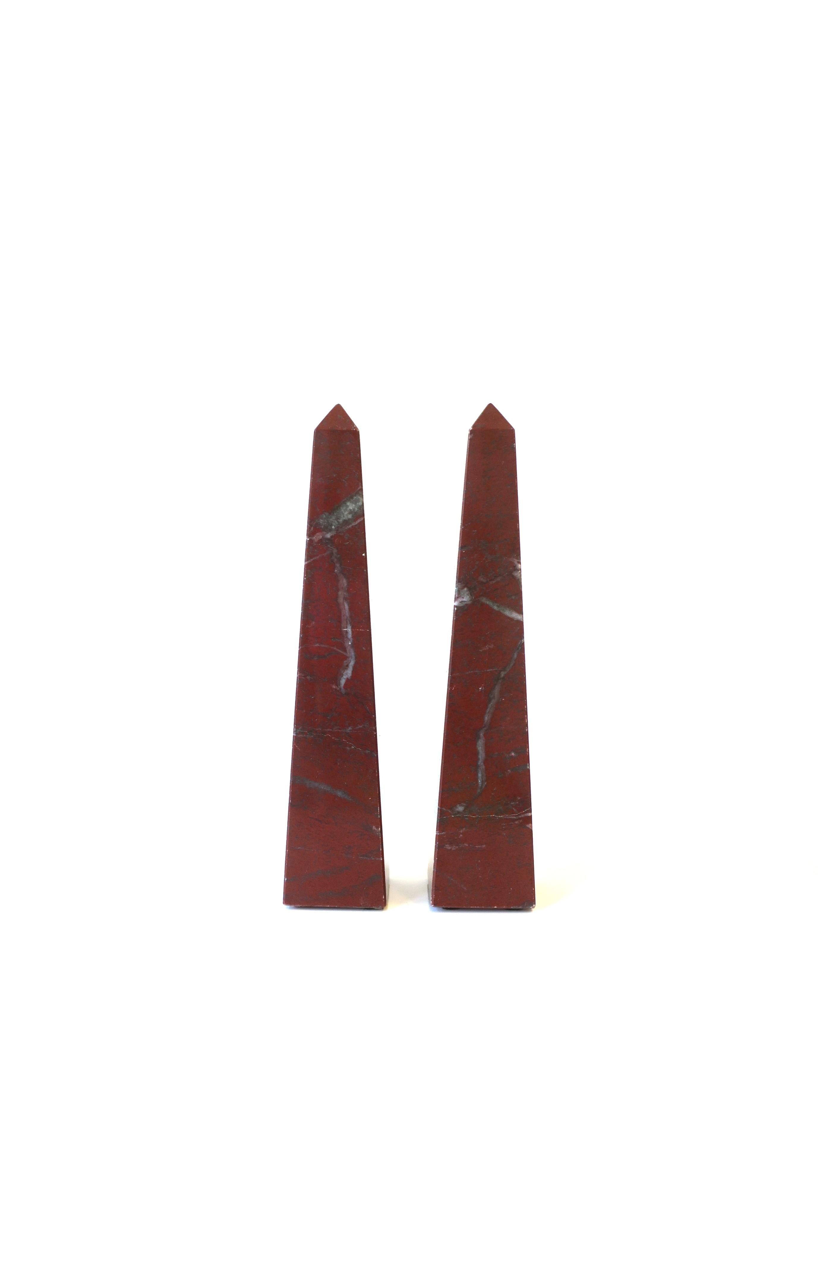 A beautiful pair of red burgundy Italian modern marble Obelisks, circa 1970s, Italy. Solid red burgundy marble with grey veining. Marked on bottom, 'Made in Italy', as shown in last image. A great set for any cocktail table, mantle, bookshelf,