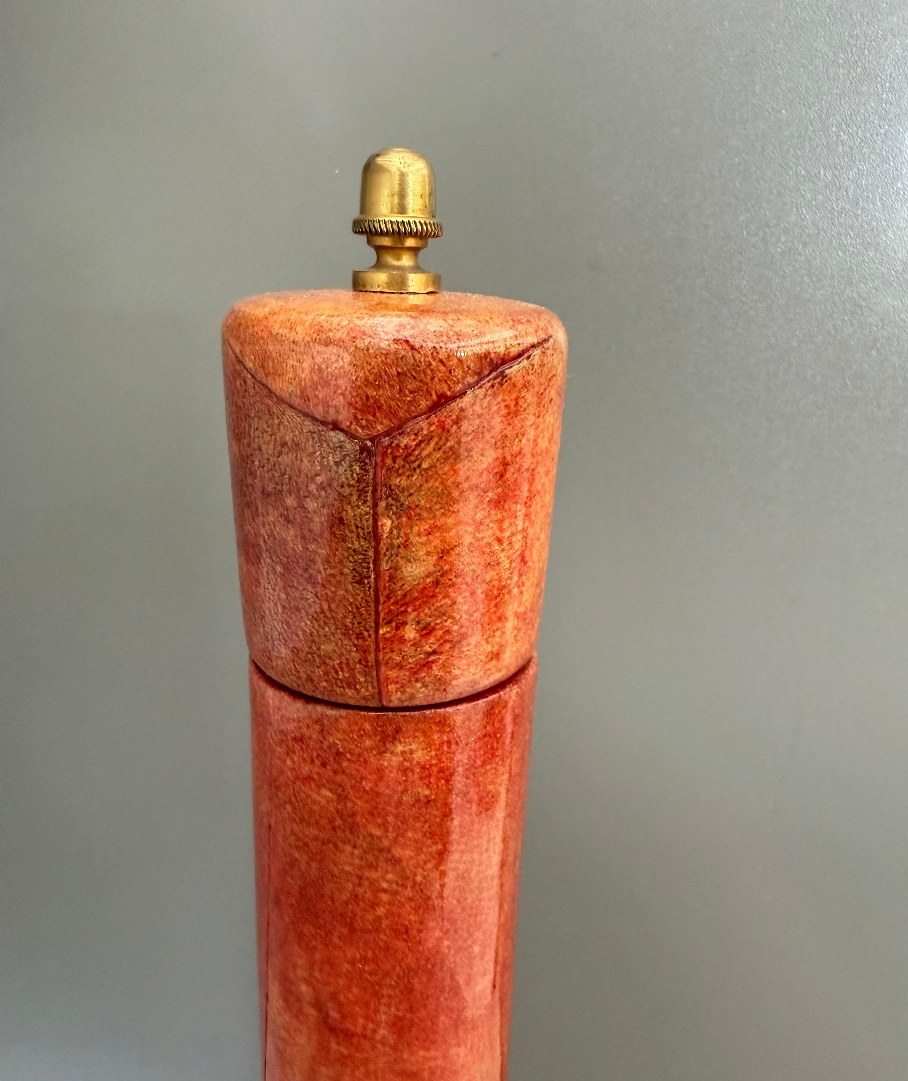 Fabulous 1970’s large red goatskin parchment pepper mill by Italian designer Aldo Tura. 

Constructed of wood covered with red dye goatskin and clear lacquer to protect it. 
In beautiful working condition. 

Measurements: 
12.75” High, 2.75”