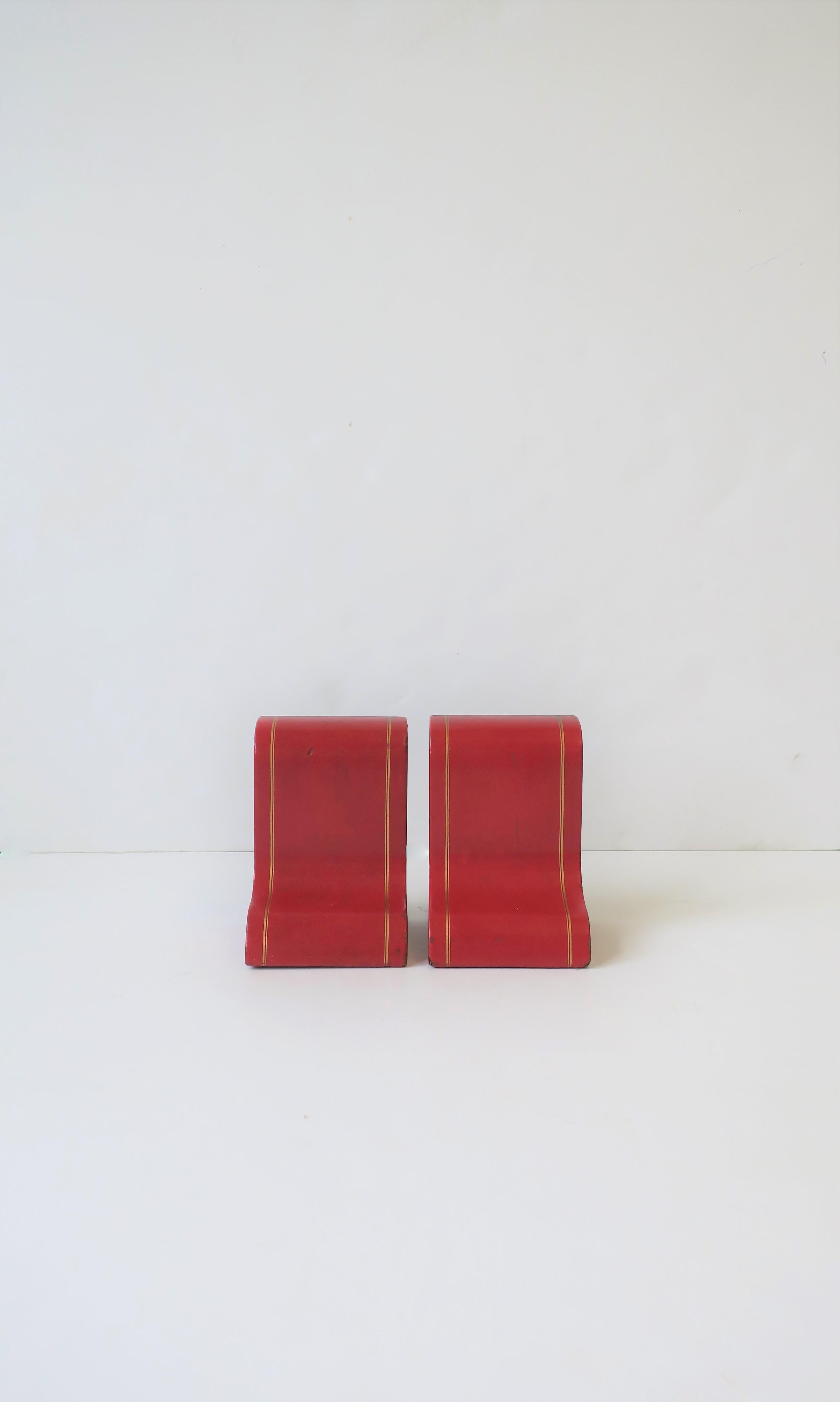A set of red leather and gold embossed bookends, circa mid-20th century, Italy. A great set for an office, library, bookshelf, etc. Dimension: 5.75