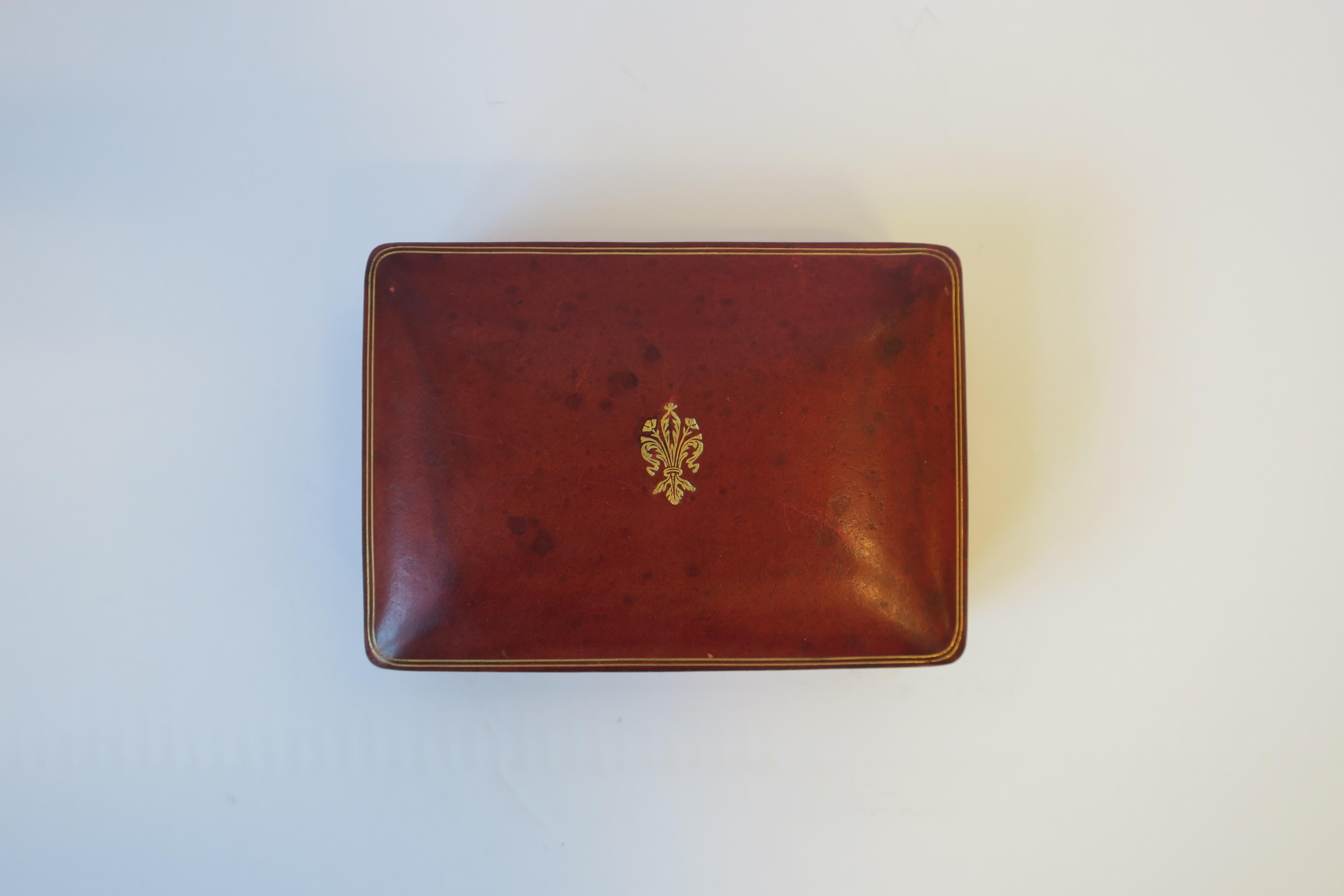 A beautiful mid-20th century Italian red burgundy or 'ox blood' leather jewelry, vanity, or trinket box. with gold embossing. Marked 'LEATHER SCHOOL FLORENCE
