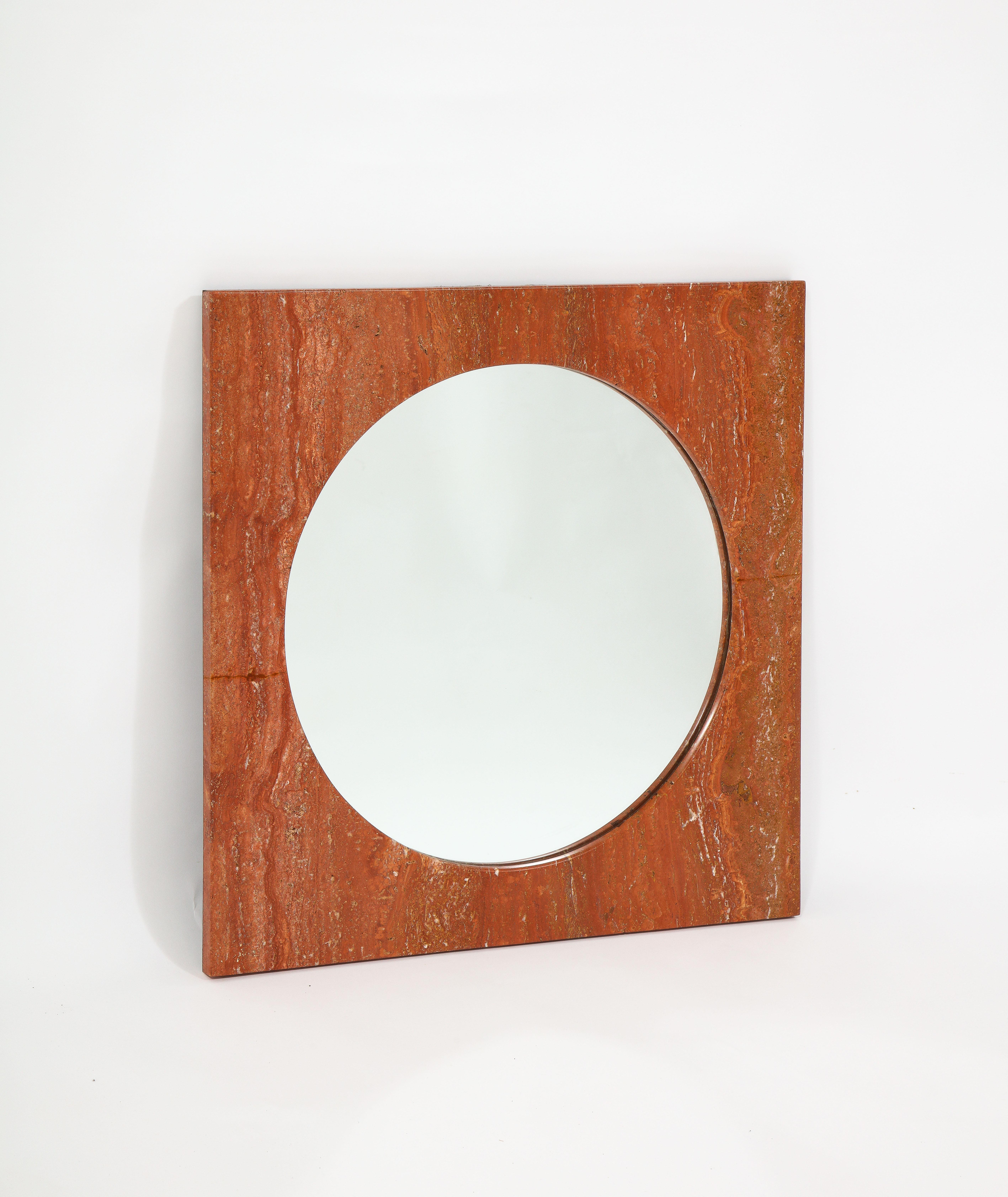 Italian 1970s red travertine square mirror. Minimalist in style, the stone frames a round mirror. 

This mirror has been restored as can be seen on detail pictures but given the structure of travertine the restoration is hardly visible as it
