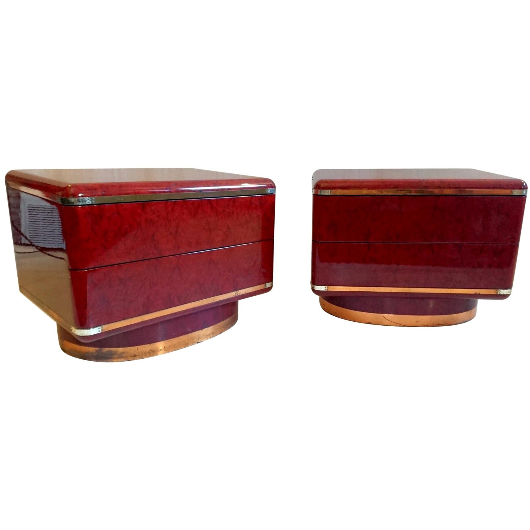 A pair of side/end tables/nightstands of very high quality. That are veneered in walnut root and copper colored metal with mahogany on the back. Each table has an oval shaped base two drawers. Great design with rounded corners and lines. The metal