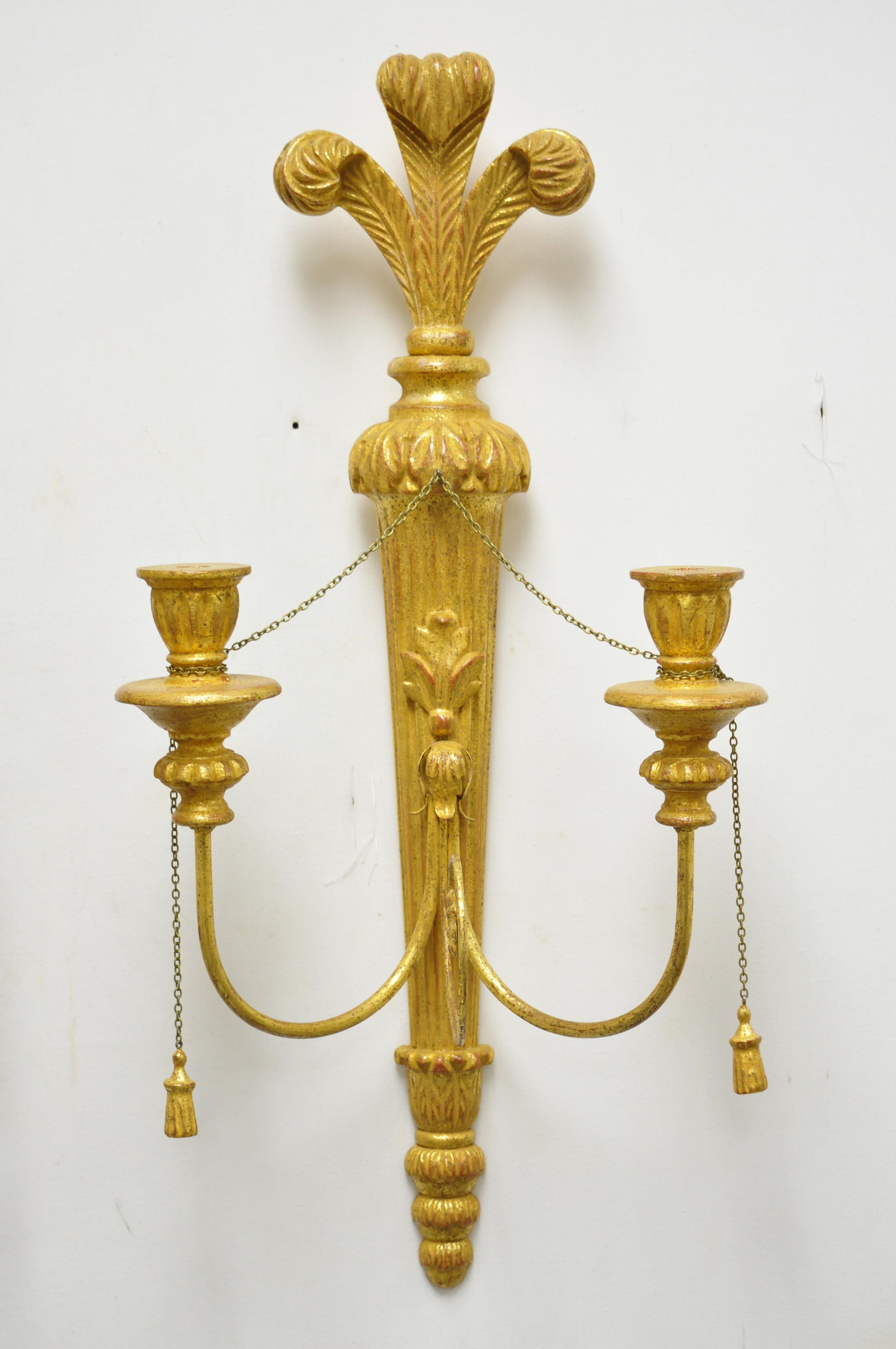 Vintage Italian Regency carved wood gold giltwood plume prince of wales sconces - a pair. Item features (2) carved wood candle holders per sconce, carved wood plume, prince of wales crest, iron scrollwork and wooden tassels. Circa mid to late 20th