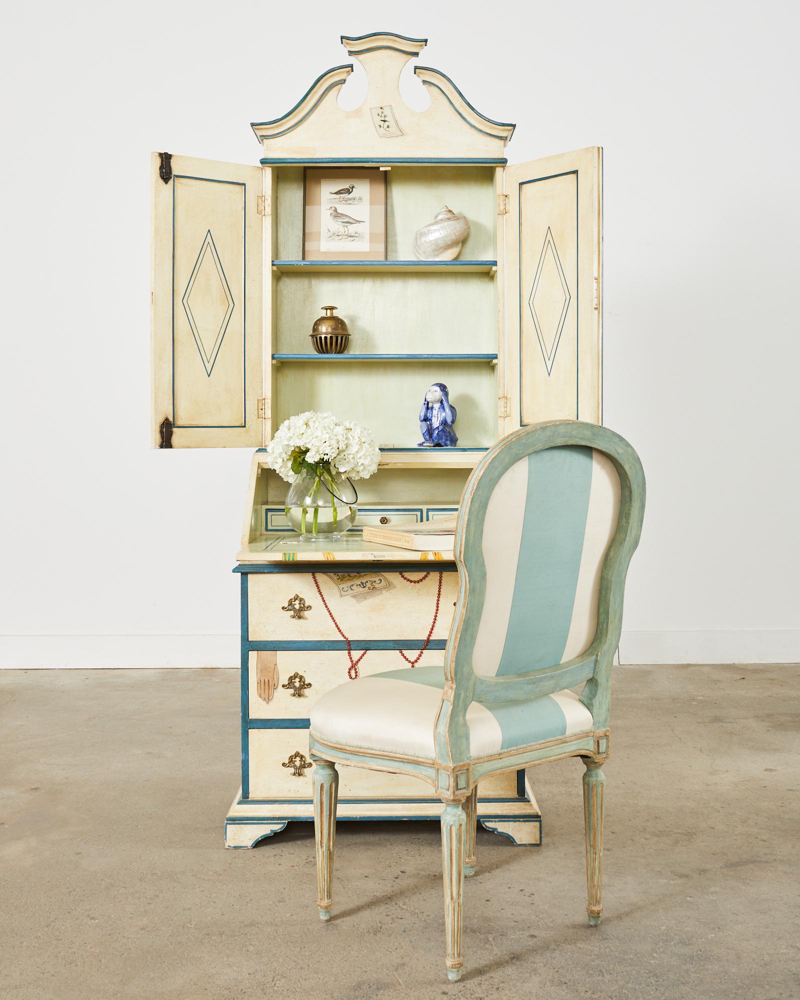 Impressive Italian regency two-part Trompe l'oeil secretaire with a drop-front desk made in Florence. The case features beautifully hand-painted whimsical motifs that decorate the case. The drop front desk measures 29.5 inches high and is fitted