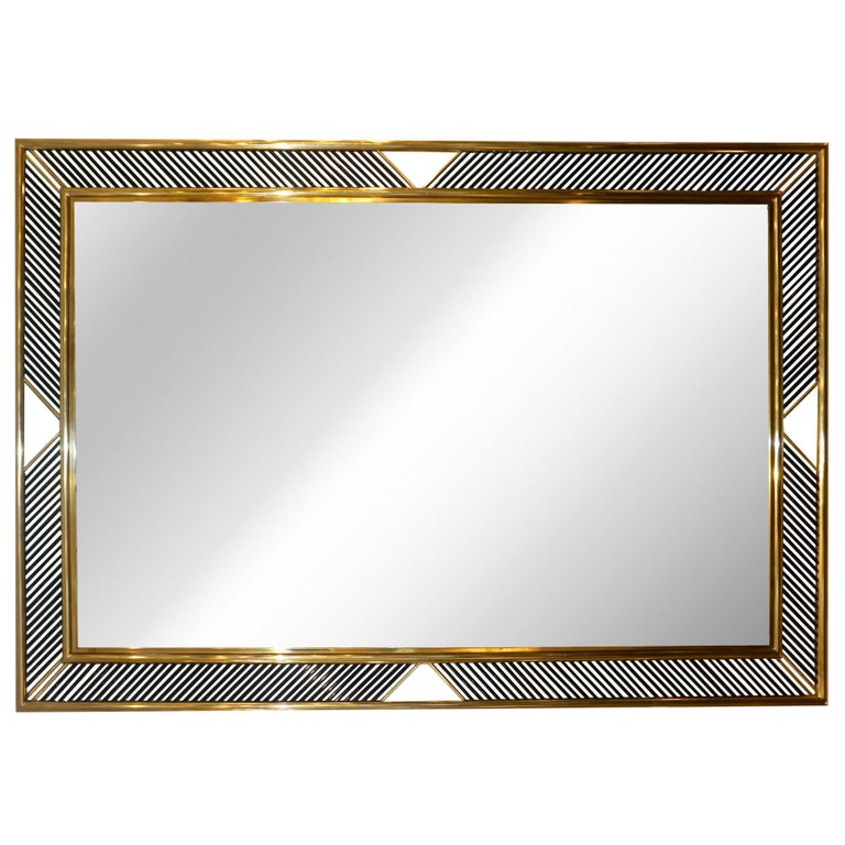 Hollywood Regency Design contemporary mirror, entirely handcrafted in Italy for Cosulich Interiors, with a modern double brass frame adorned with exquisite Murano glass rods in a solid black color that can be customized. The craftsmanship is of high