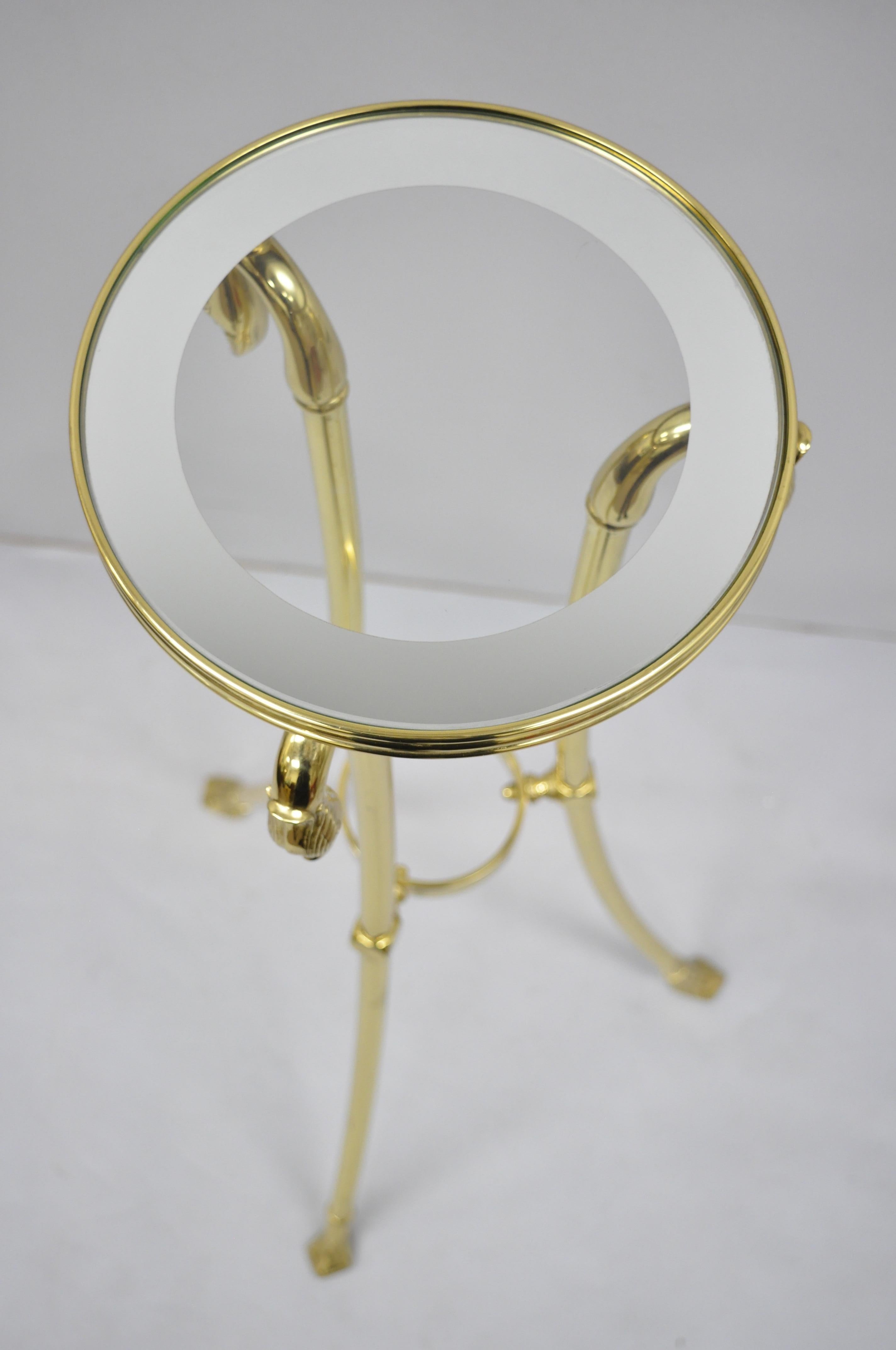 Italian Regency neoclassical style brass pedestal with swan heads. Item features polished brass frame, 3 swan heads, round glass top with mirror border, original label, great style and form, circa 1970s. Measurements: 42.5