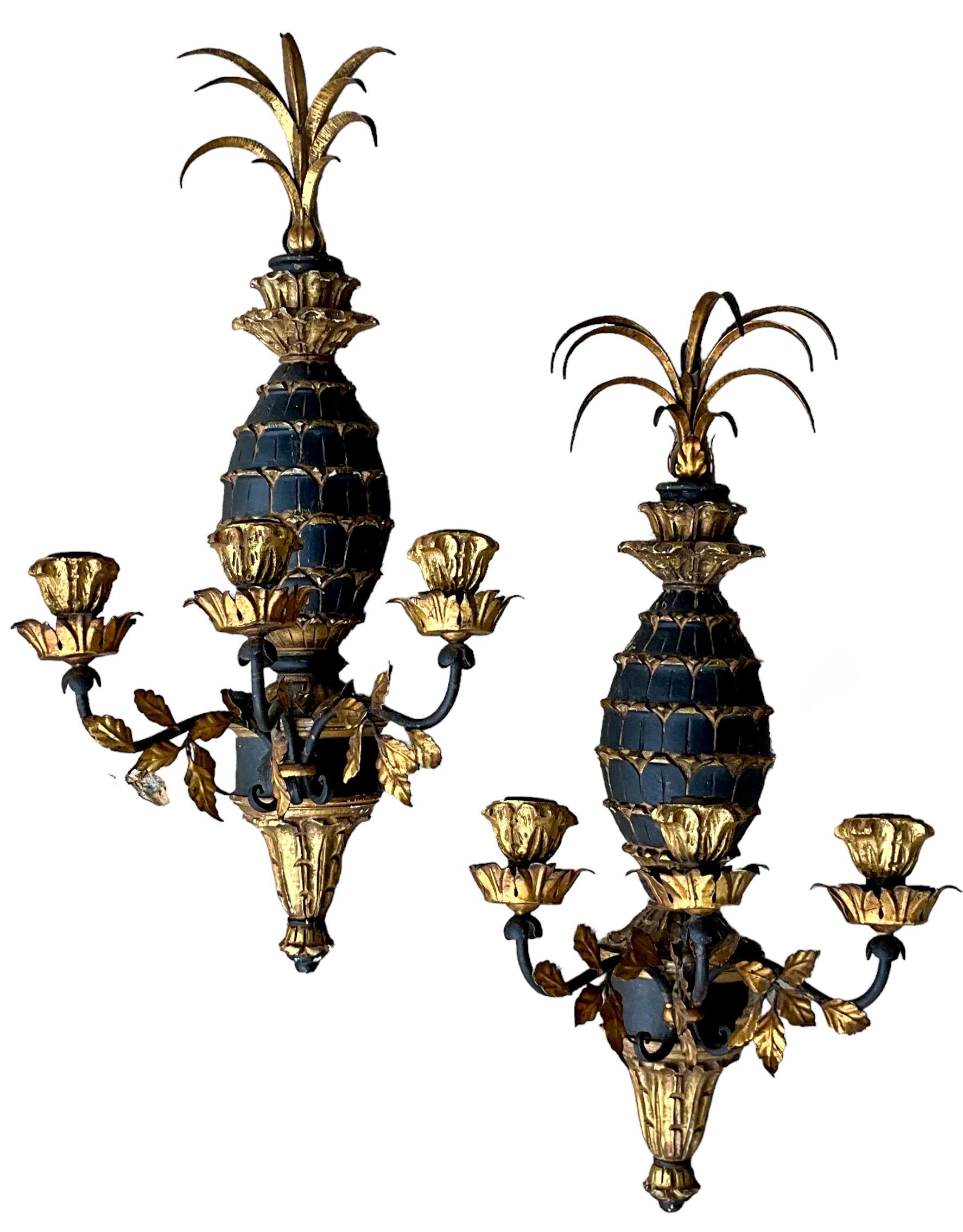 This is a pair of 1960s regency style carved pineapple sconces with gilt metal tole fronds. They are not electrified.Both sconces have a chippy patina. 

My shipping is for the Continental United States only. 