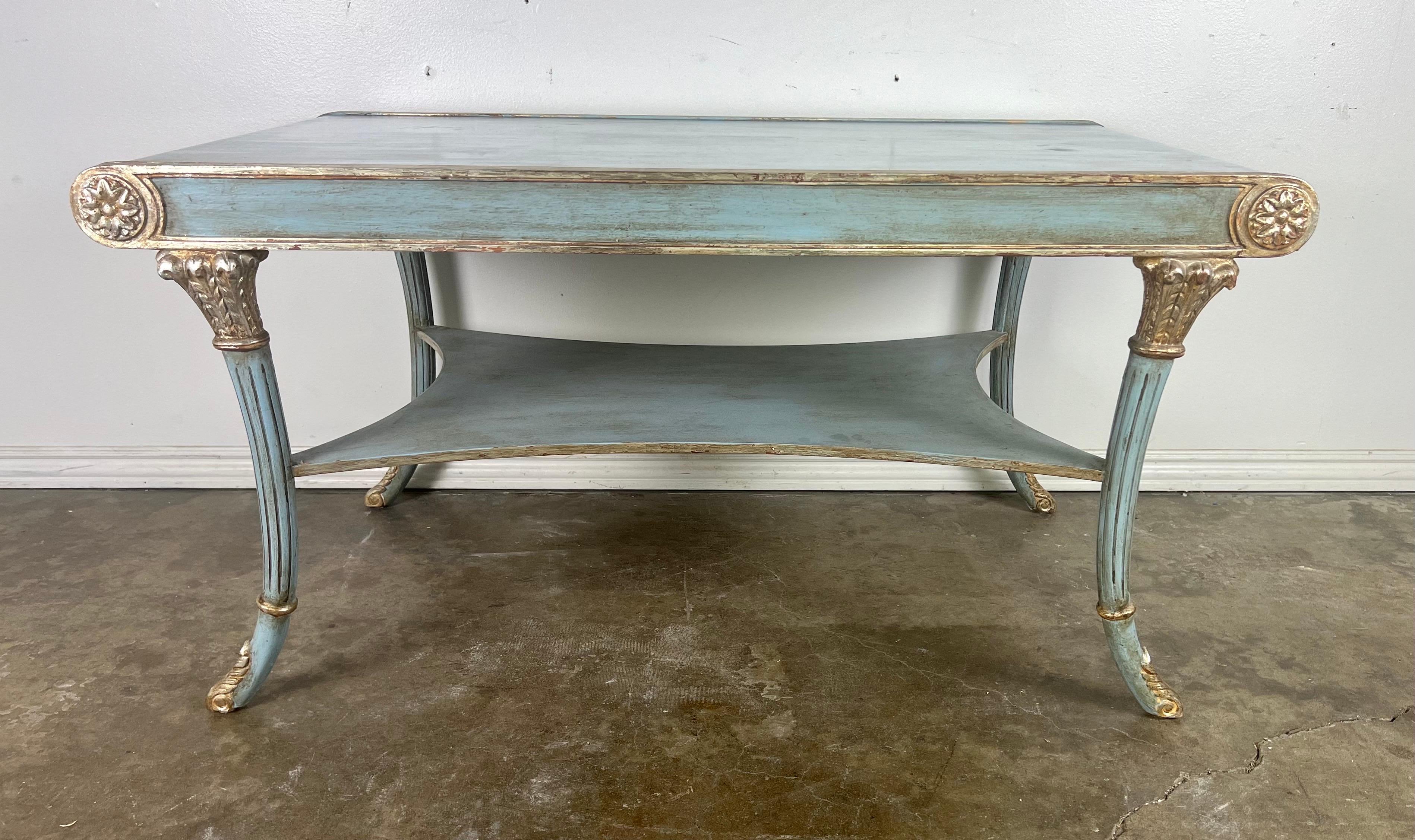 This 1980's Italian Regency style tea table designed by Nancy Corzine beautifully encapsulates the elegance and grace of its era and design influences.  The soft blue coloration provides a gentle, inviting appearance, which is elegantly offset by
