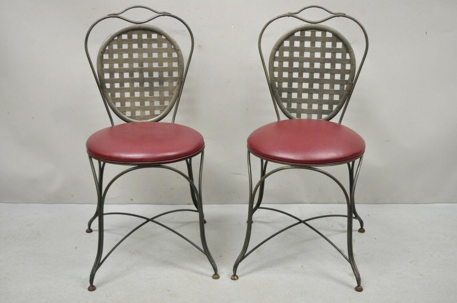 Italian Regency style wrought iron sunroom lattice round seat side chairs - a pair. Item features a pierced lattice back, stretcher base, red vinyl upholstered round seats, quality craftsmanship, great style and form. Circa Late 20th century.
