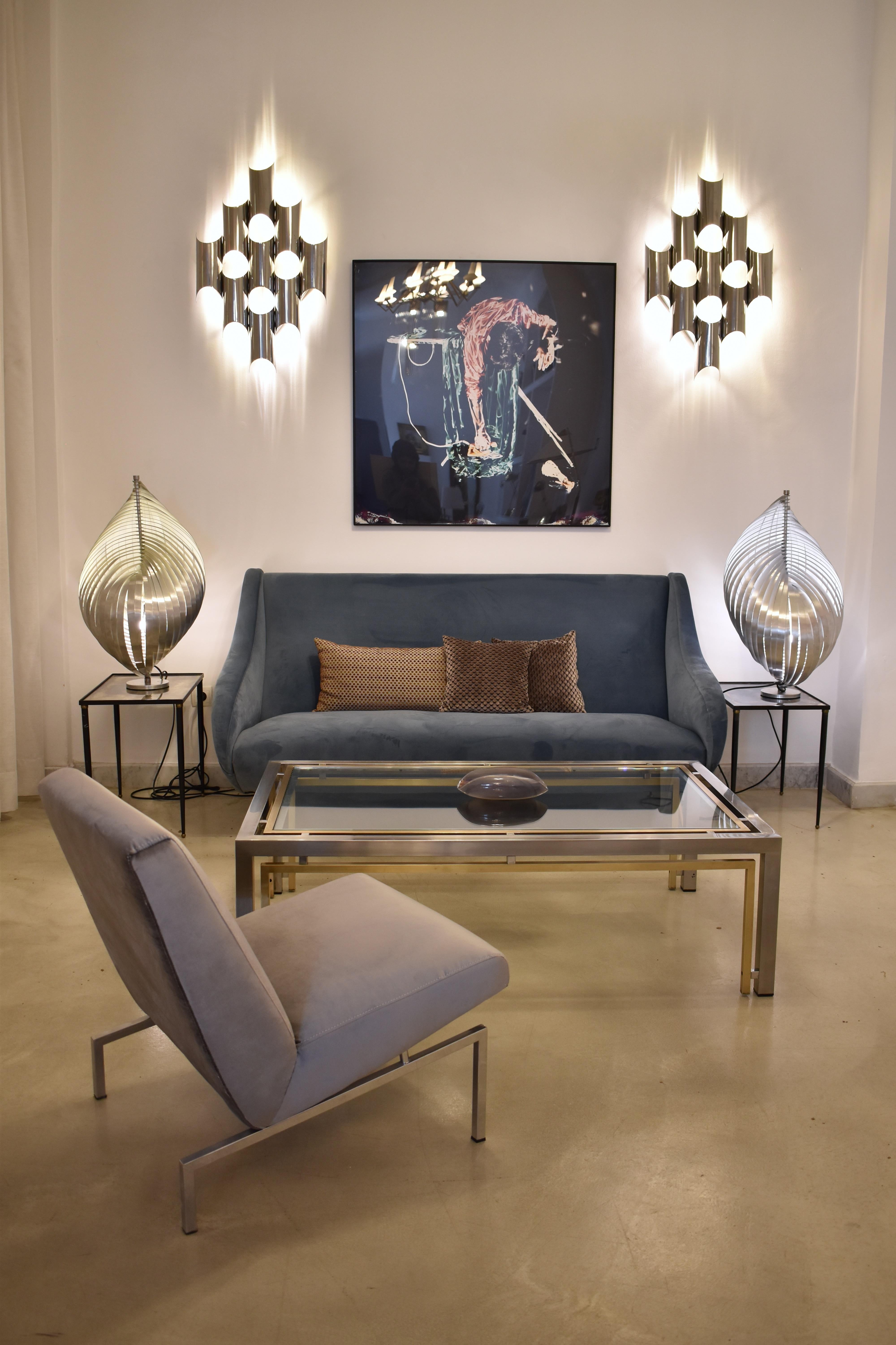 A pair of Italian vintage sconces by Goffredo Reggiani from the 1970s, featuring sculptural chrome tubes arranged in a bold geometric design. These vintage fixtures bring a futuristic style to any space with their striking form and high-quality
