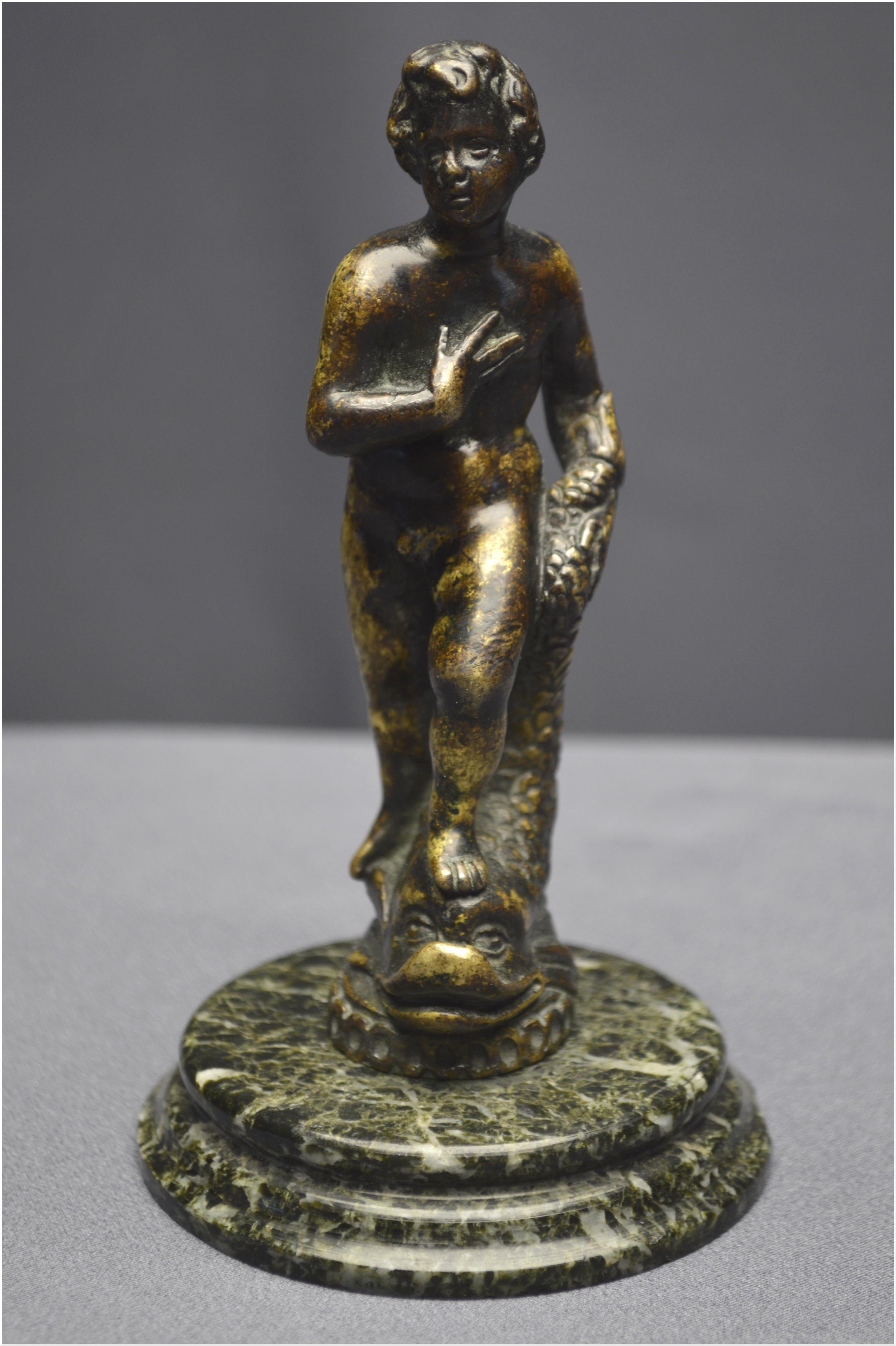 Italy, Renaissance period, 16th century, Bronze statuette representing a young man with a dolphin.

Italy, possibly Florence
Renaissance period, 16th century

Rare bronze statuette representing a naked young man with a dolphin. He is shown standing