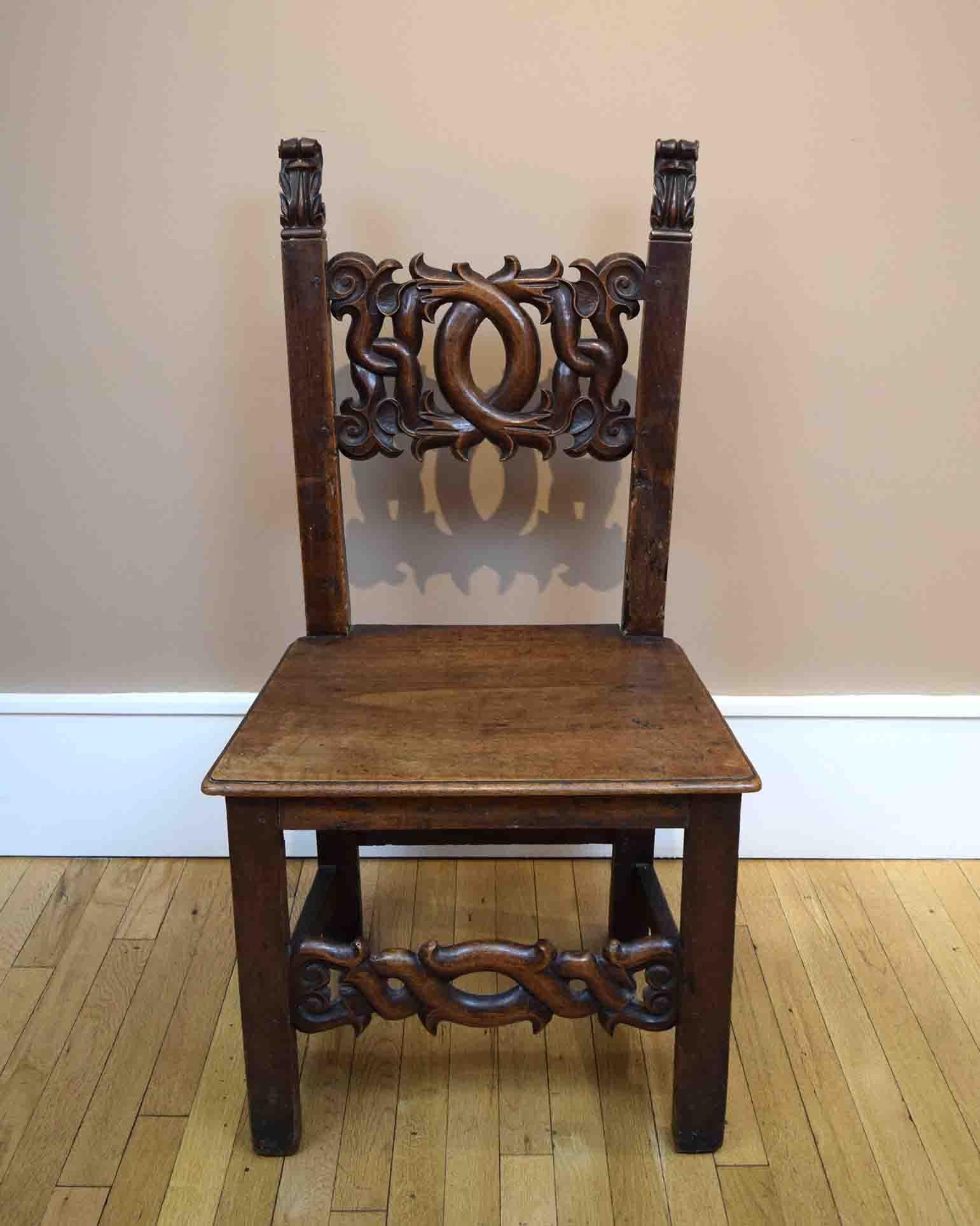 Over the course of five centuries of use, this Italian Renaissance walnut chair has acquired a rich patina. Its austere form is relieved by the sensuously carved back splat and front stretcher. We purchased the chair in Paris from Pierre Le-Tan, the
