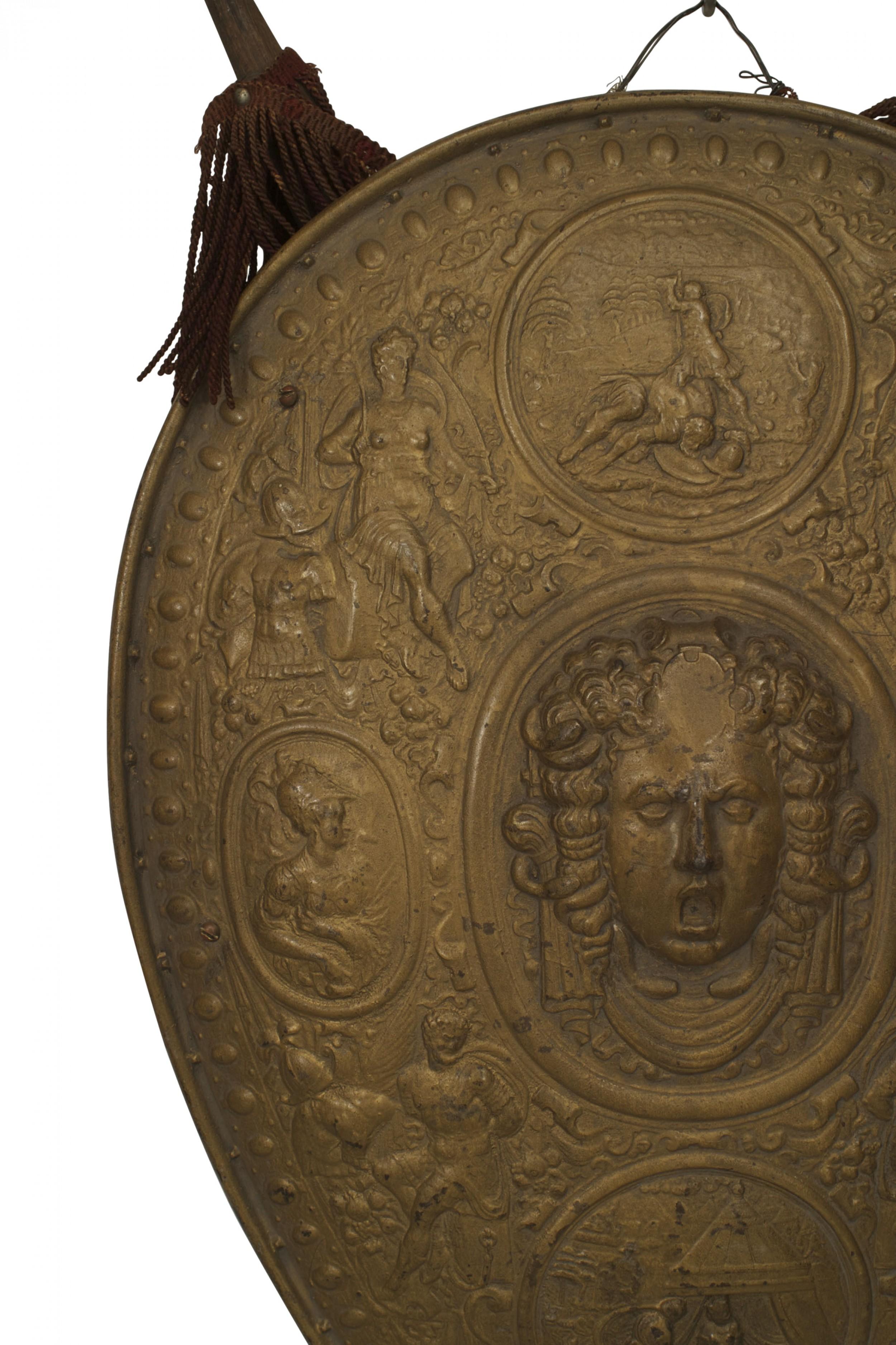 Italian Renaissance-style (19th/20th Century) gold painted metal shield with classic head center surrounded by Renaissance figures.