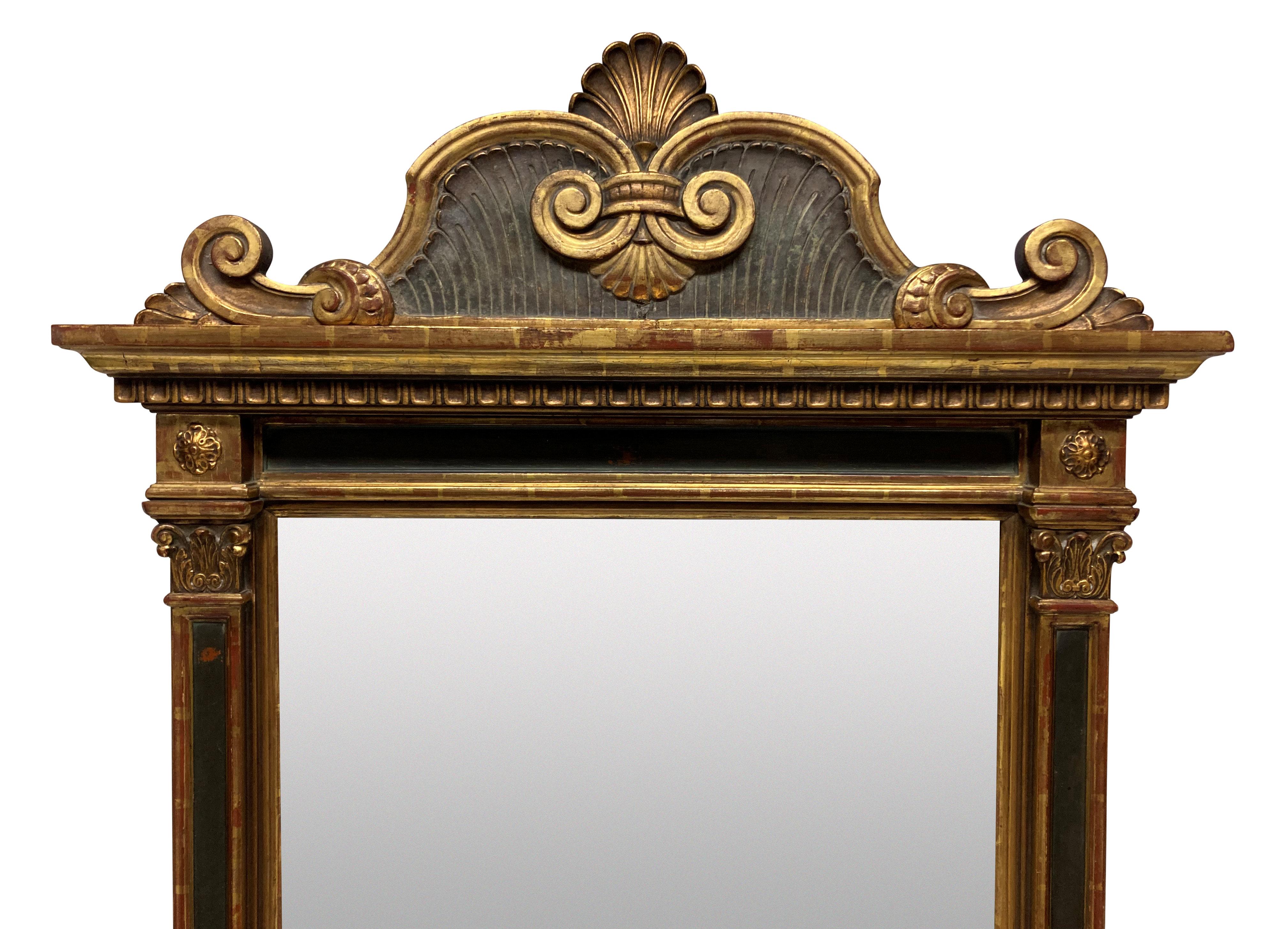 A large Italian giltwood mirror in the style of a Renaissance tabernacle. Pedimented, with its original gilding and paintwork throughout. It has an old mirror plate with minor loses in places. This mirror is very heavy and has a deep stepped base,