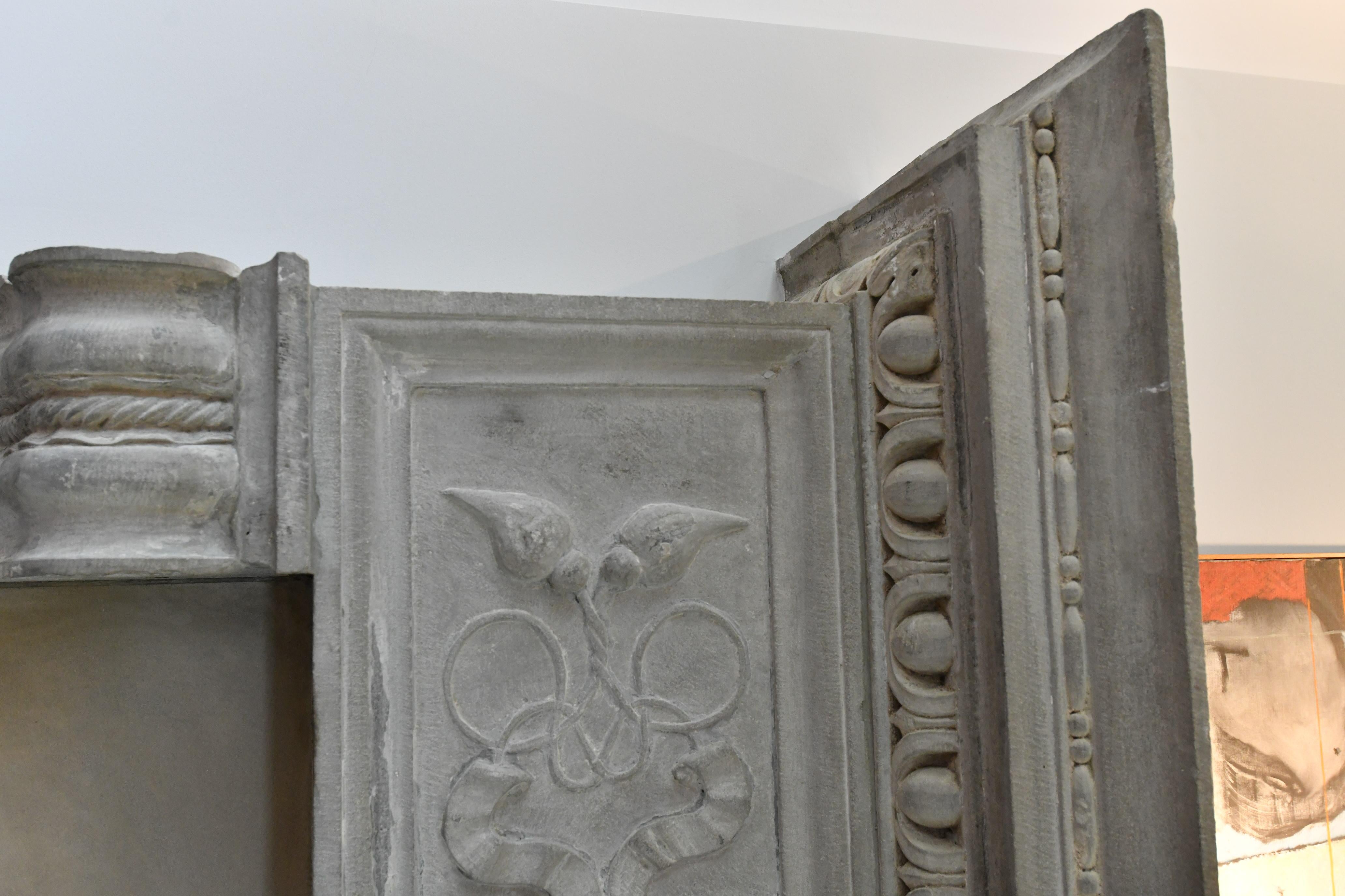 A handsome 19th century Italian chimneypiece in the Renaissance style. Carved in Limestone the chimneypiece displays imposing proportions, standing at over seven feet tall. Pilasters with fielded panels terminate in corbels decorated with rope twist