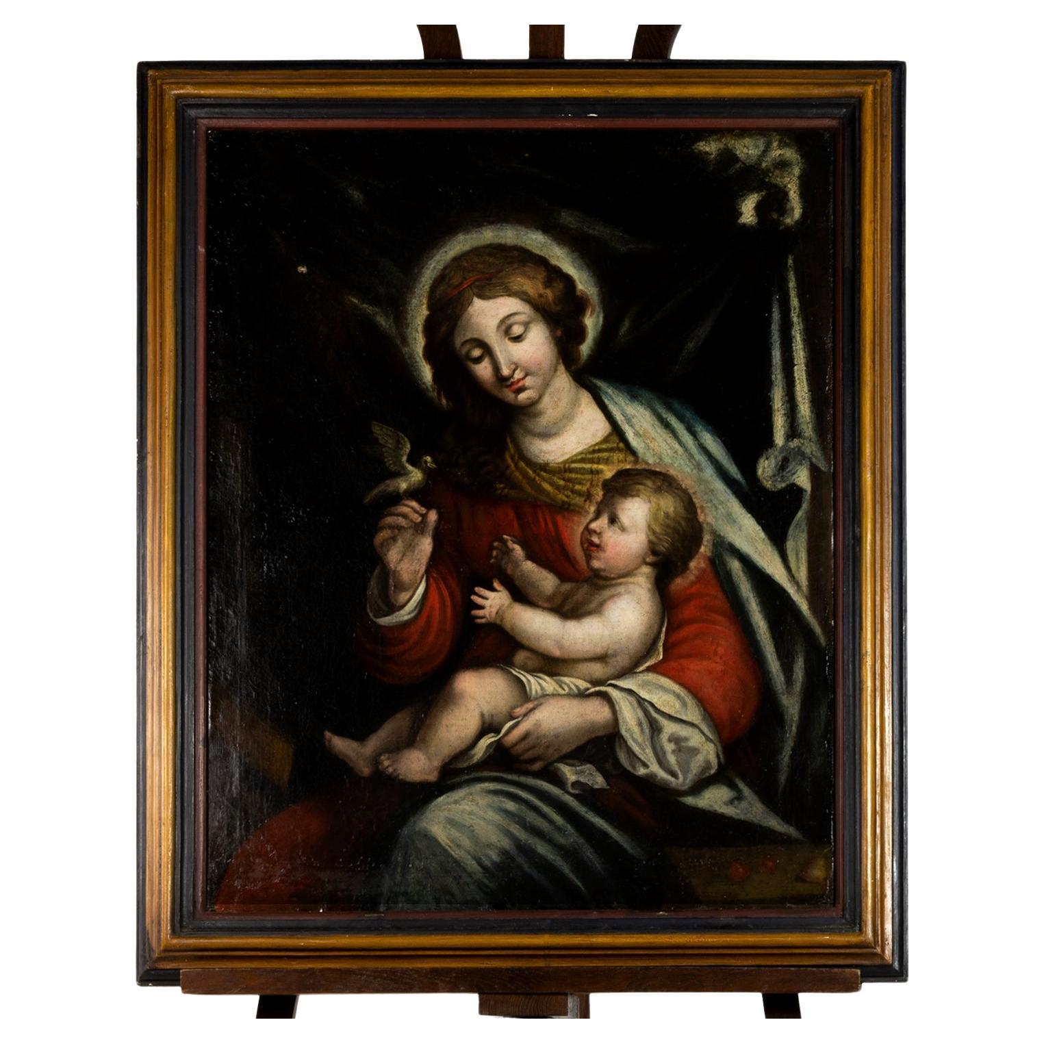 A Renaissance oil painting of Our Lady of Peace, Mary with Jesus Christ, Prince of Peace on her arm in a dark background, red and green robes, the Mother is represented  holding a dove (a symbol of peace) with her left hand and the boy Savior in the