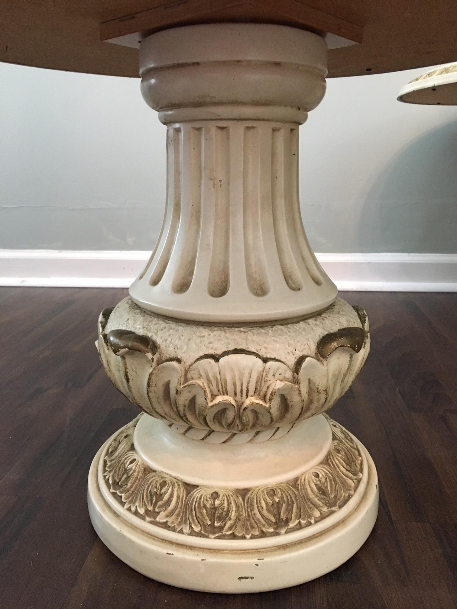 Pair of Italian style column side tables feature marbled glass tops and carved detailing. Perfect for your Hollywood Regency decor. Good vintage condition with one chip at base bottom rear.
