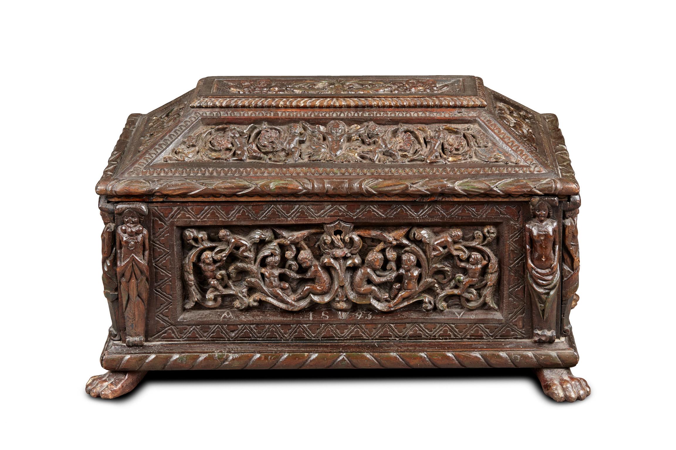 Late 16th century Italian Renaissance painted deal casket, dated 1593.
 
The casket with raised lid all carved with Cherubs and floral interlace bordered by bold acanthus. The front panel of interlaced Putti and Cherubs above a mask, flanked by