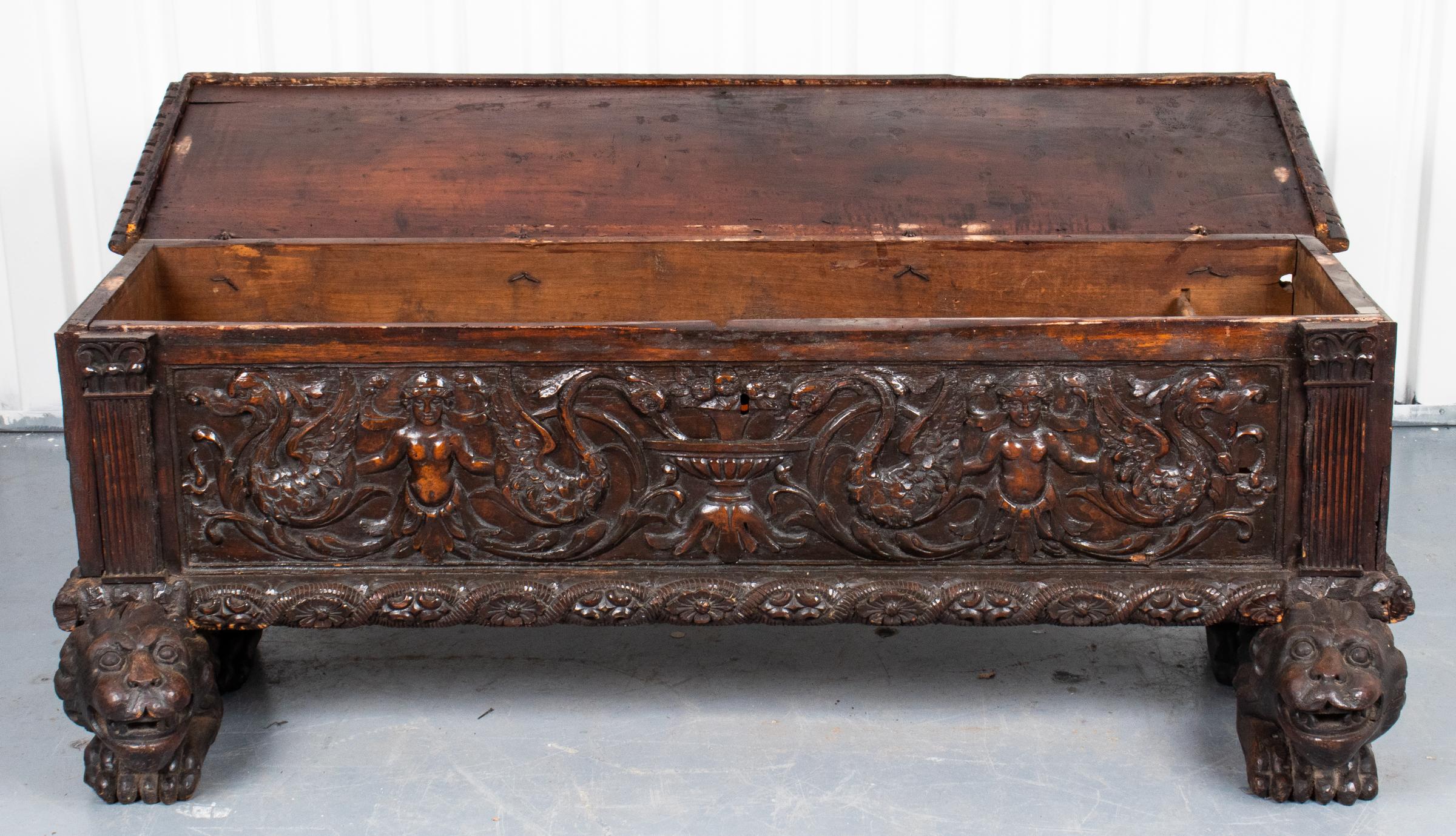 Antique Italian Renaissance revival oak cassone, the chest carved throughout with Classical motifs and raised on lion-head bracket feet. Measures: 24