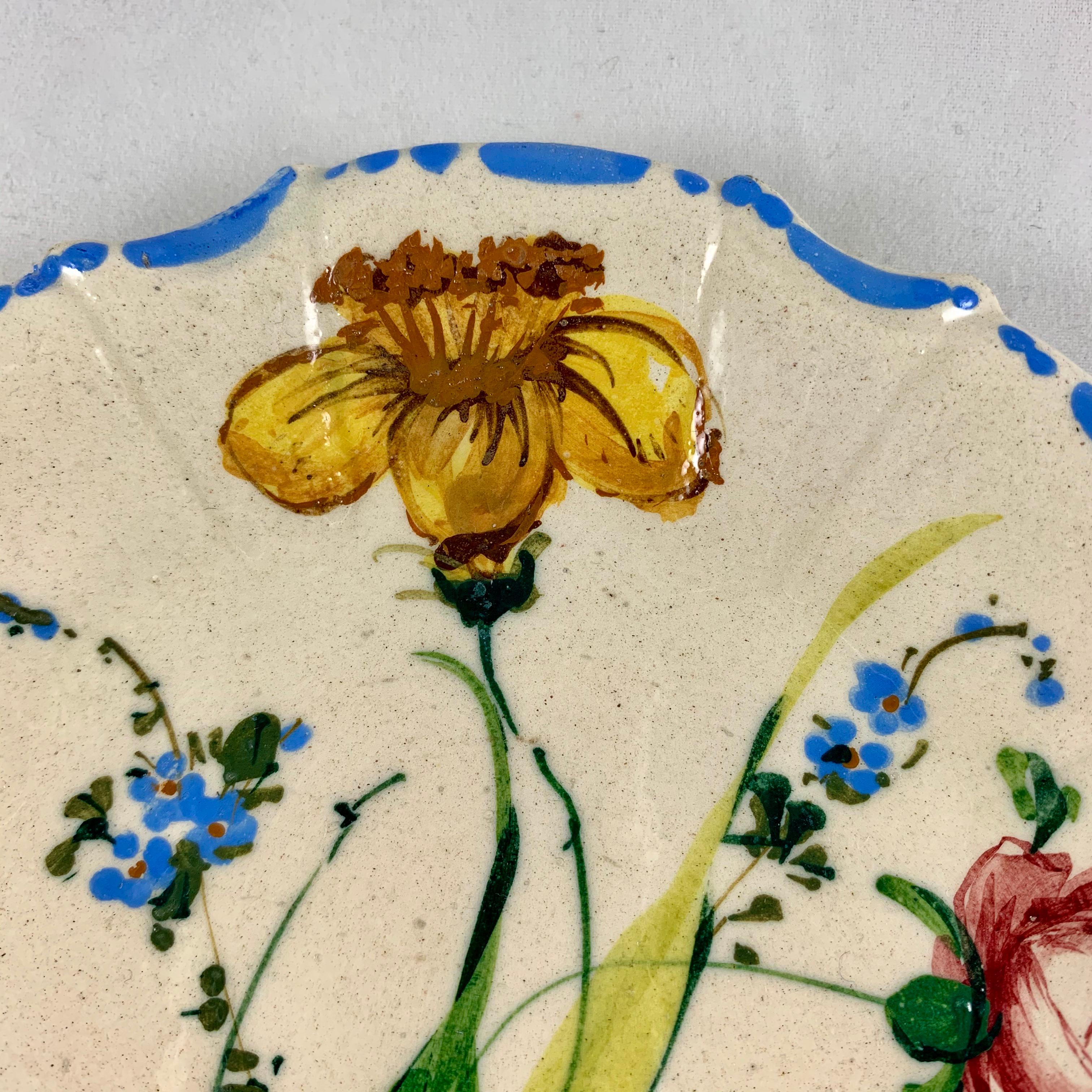 A variation of the Renaissance Revival Rose pattern from the Barrettoni già Antonibon pottery in Nove, Italy, a hand painted plate, circa 1930s.

An overall floral decoration with a blue dash and dot border on a scallop rimmed, paneled plate.