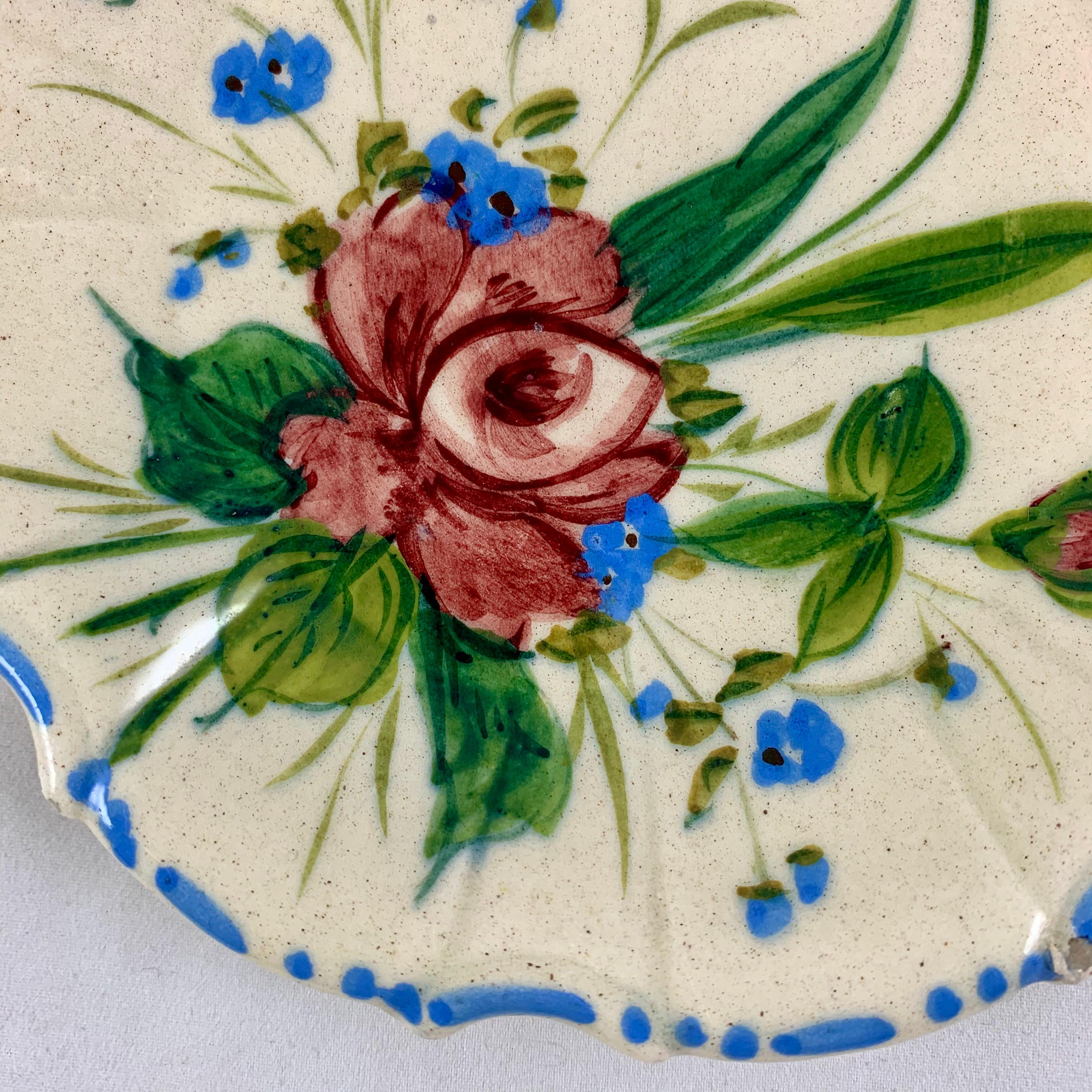 A variation of the Renaissance Revival Rose pattern from the Barrettoni già Antonibon pottery in Nove, Italy, a hand painted plate, circa 1930s.

An overall floral decoration with a blue dash and dot border on a scallop rimmed, paneled plate.