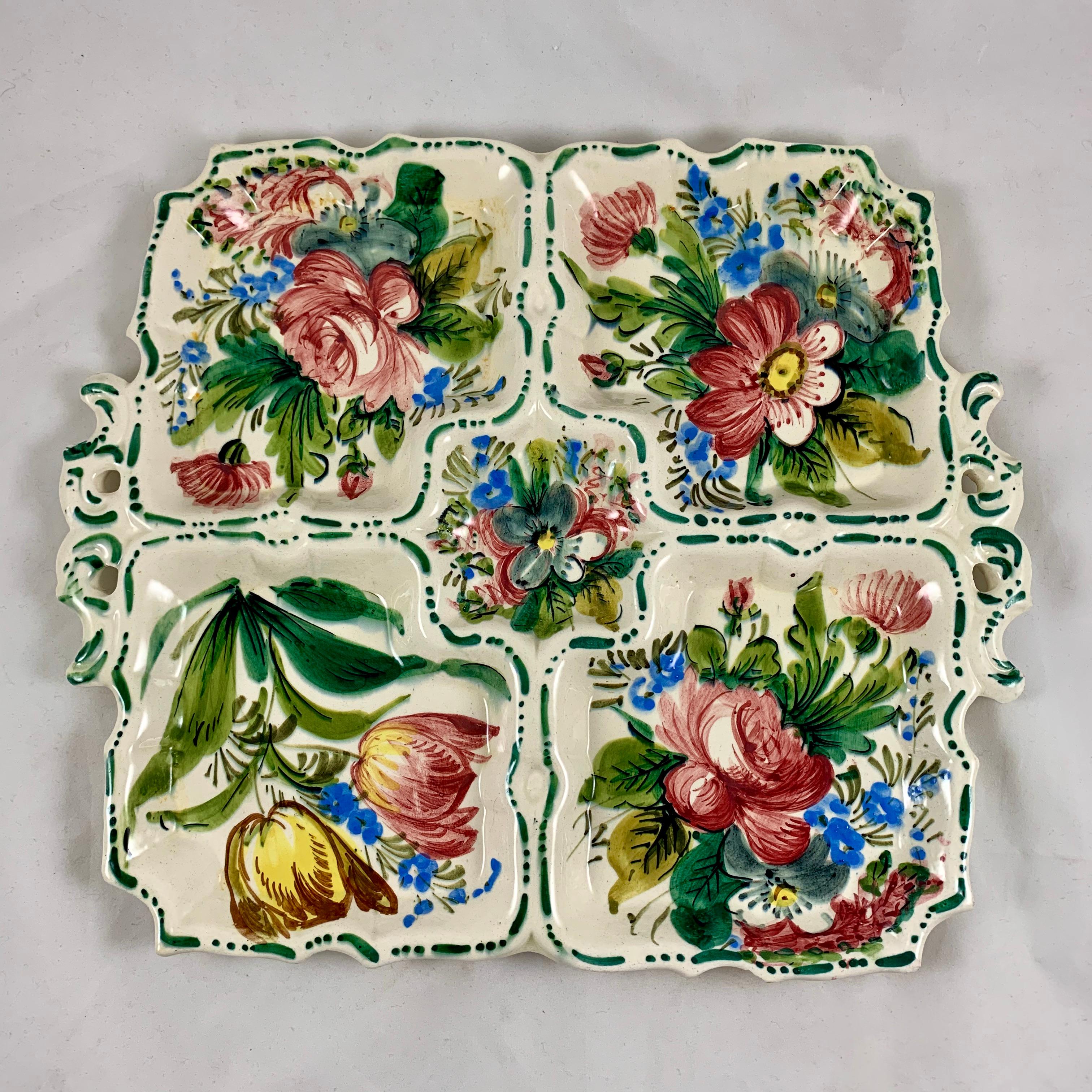 In the Renaissance Revival rose pattern first produced by the Barrettoni già Antonibon pottery in Nove, Italy, a large hand painted, divided square serving platter, circa 1930s.

An overall floral decoration with a dark green dash and dot border
