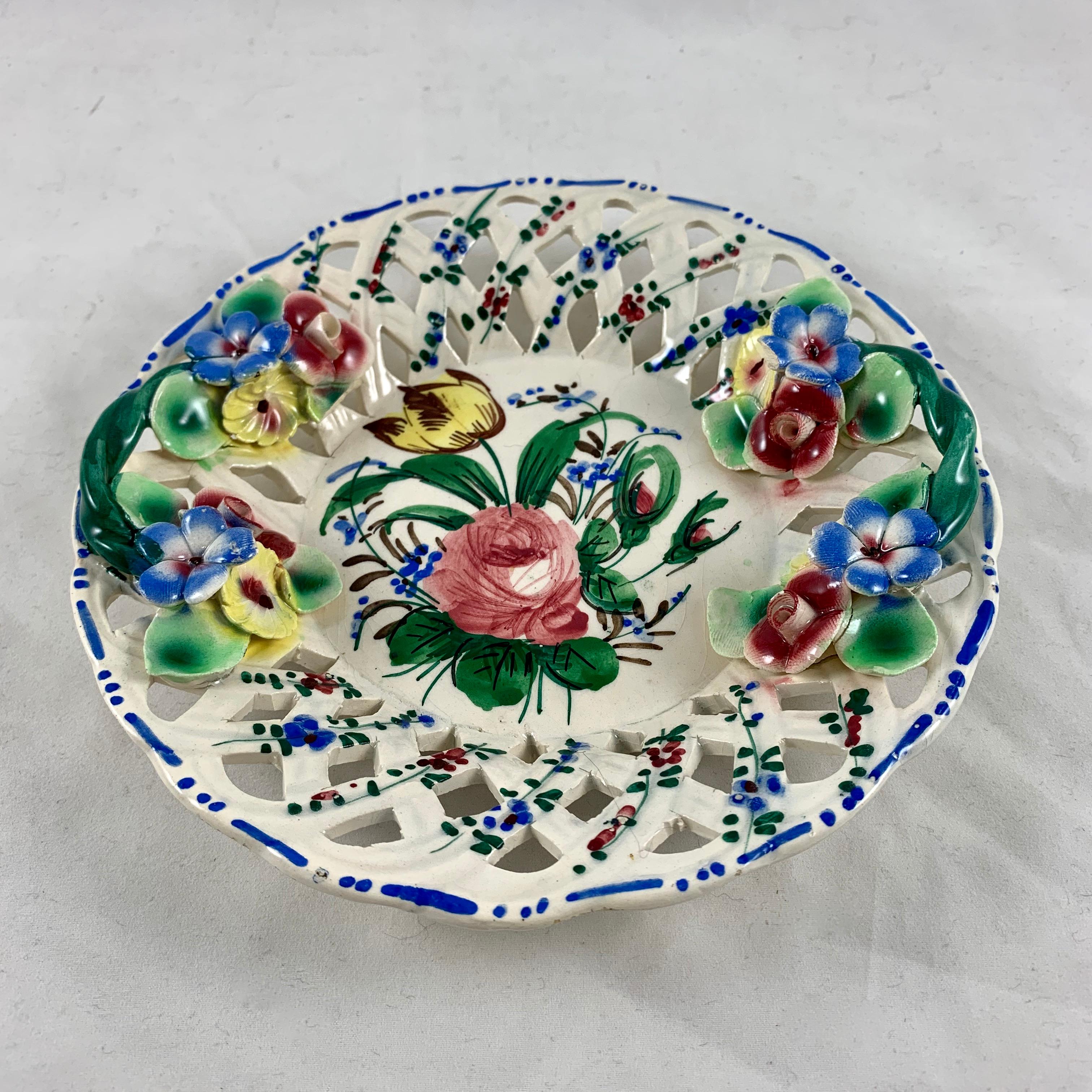 In the Renaissance Revival rose pattern from the Barrettoni già Antonibon pottery in Nove, Italy, a vide-poche, or catchall dish, circa 1930s.

Showing cut fretwork, hand applied flowers, twisted handles, and overall hand painted floral