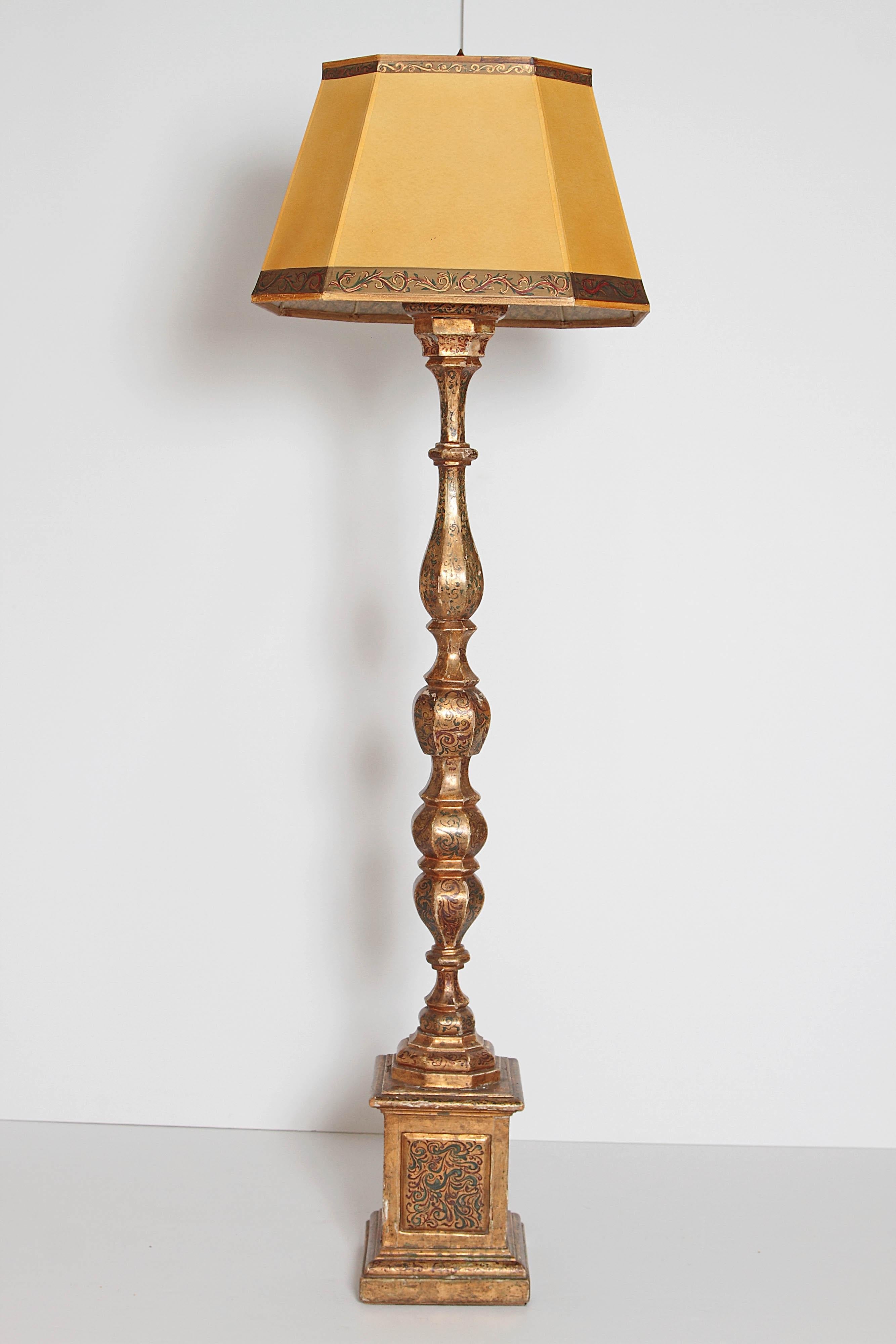 An elaborately decorated gilt turned floor lamp on pedestal base. Painted floral pattern decorations in gesso and gilt. Includes custom coordinated shade, early 20th century, Italy.