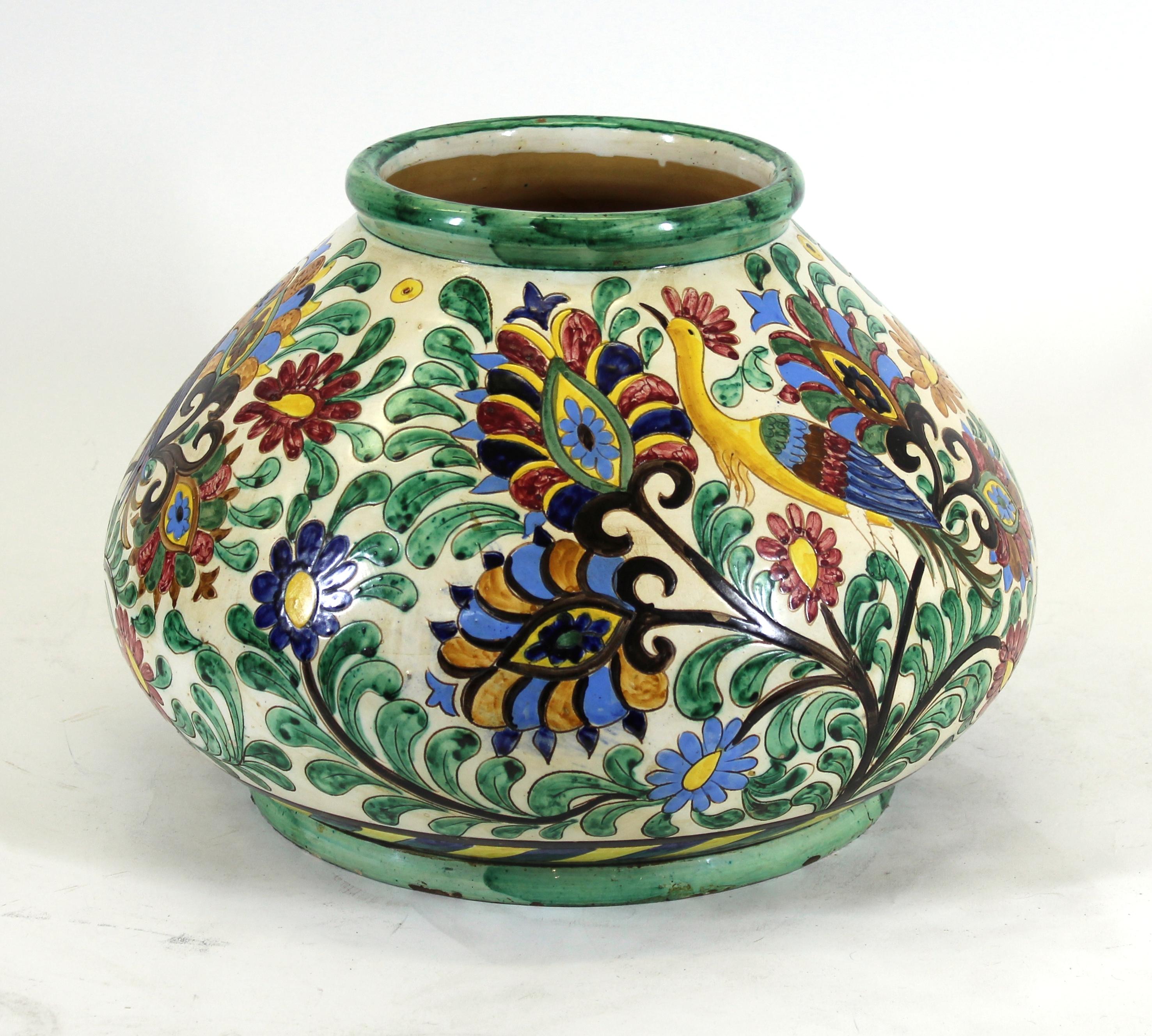 Italian Renaissance Revival large majolica centerpiece vase with painted sgrafitto of floral theme with birds of paradise. Made in Italy during the 1910's, the piece is marked on the bottom and in remarkable antique condition.