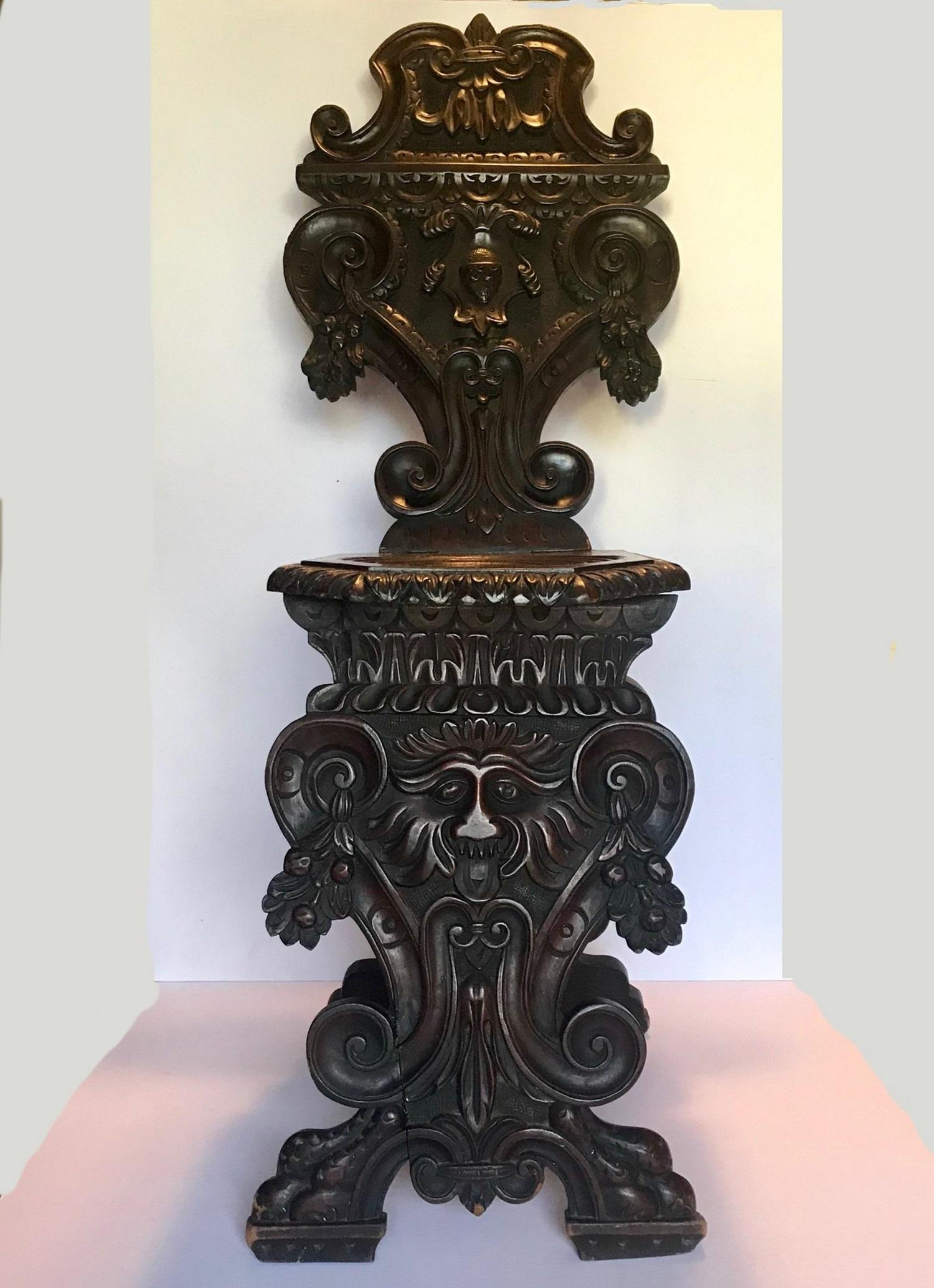 A fine Italian 19th century heavily carved Sgabello side chair. The entire front surface is hand carved and is beautifully sculpted. These hall chairs were placed against the wall and subsequently didn’t need to be decorated on the back. In the