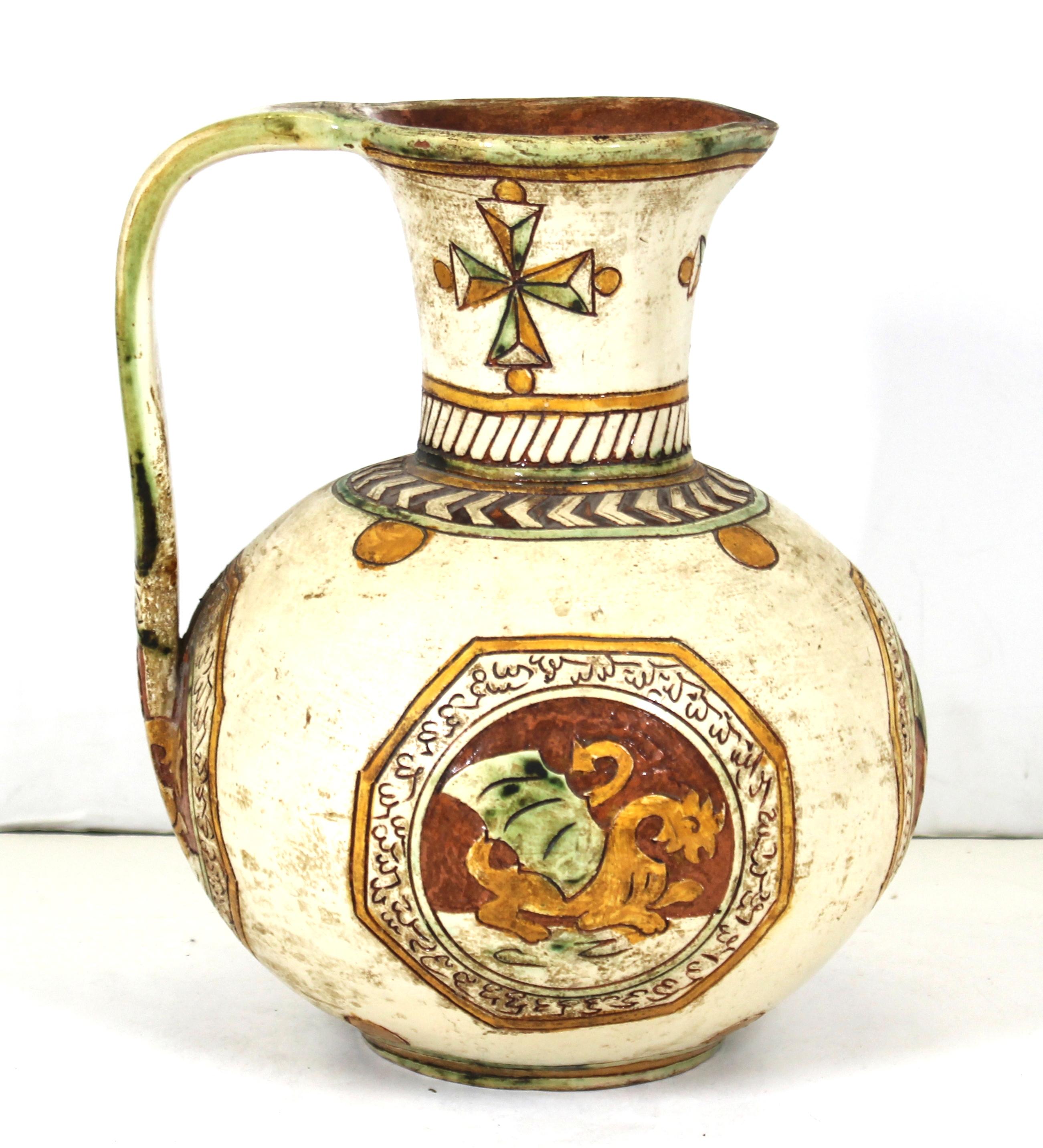 Italian Renaissance Revival ceramic pitcher with sgraffito decor of Maltese crosses on the neck and medallions depicting dragons. Made in Italy during the 1900s, this piece is in remarkable antique condition with age-appropriate wear and use.