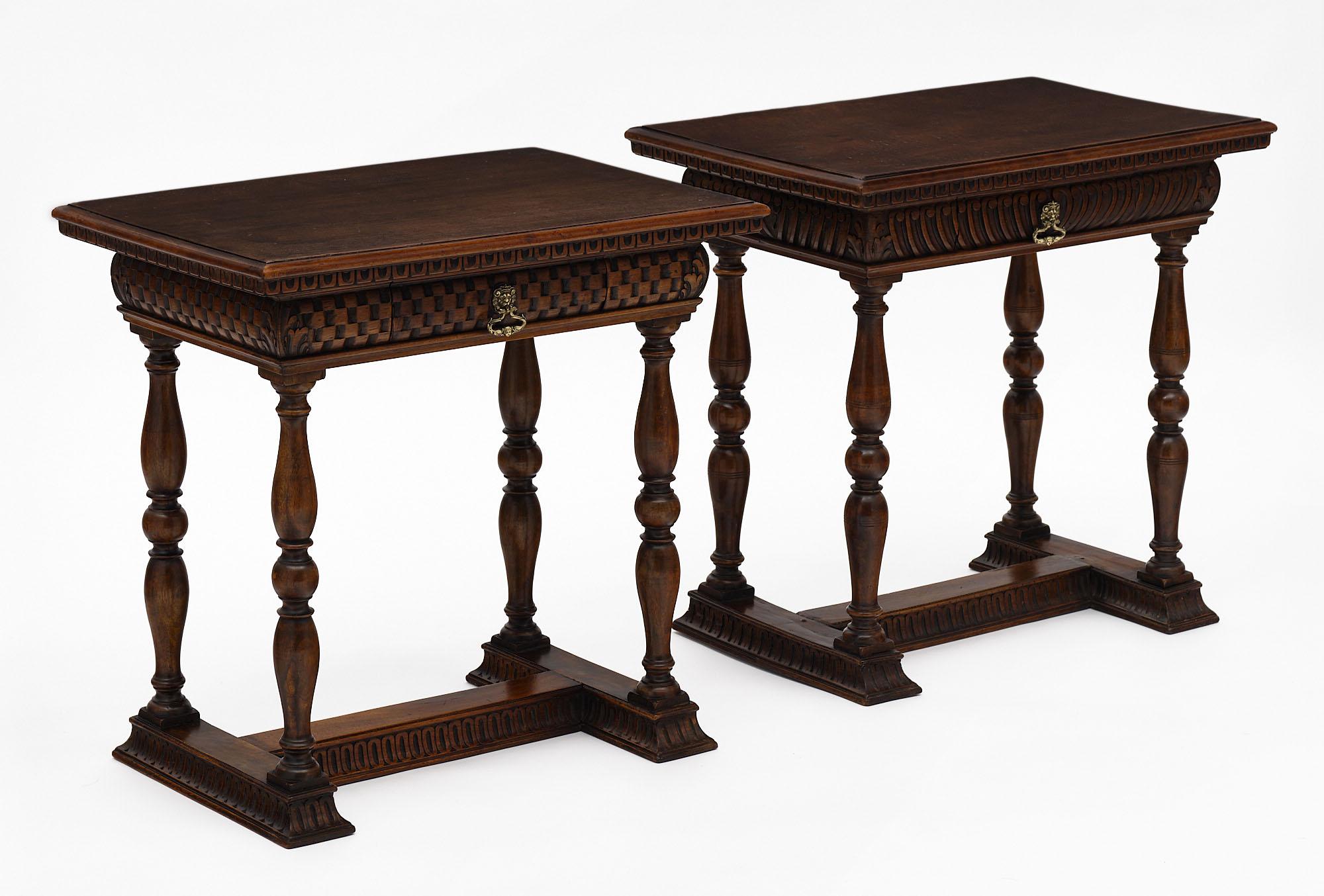 Pair of side tables from Tuscany in Italy made of hand-carved walnut with turned legs and h-stretcher. Each features a single dovetailed drawer with a lion-head pull. As they are hand-carved, the carved designs are each unique. We love the deep