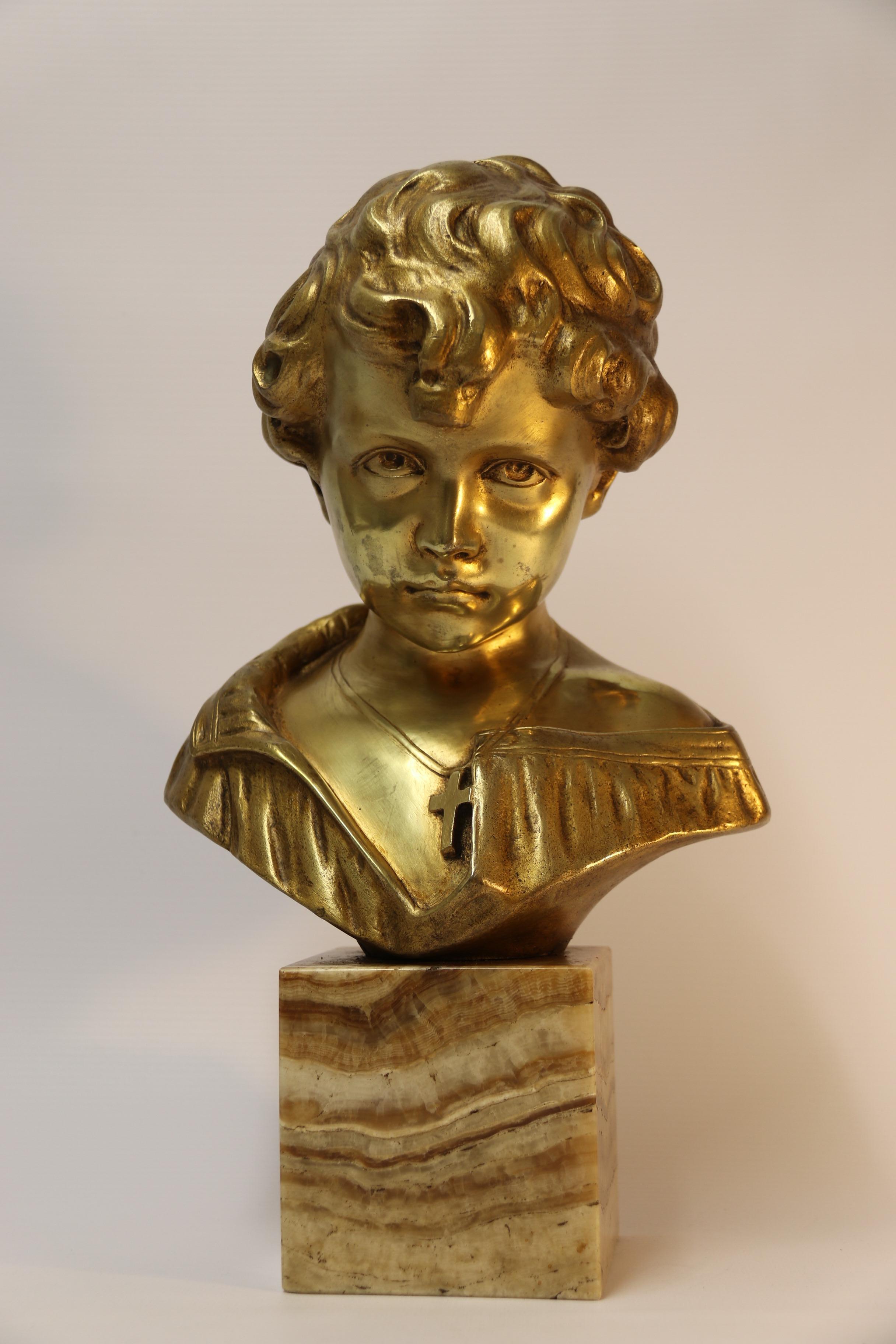 This superb bronze is full of character. It depicts a boy with his head slightly bowed, the eyes are cleverly uplifted which captures great expression.
This piece is cast with good detail with a rich gilt finish and is mounted on a block of